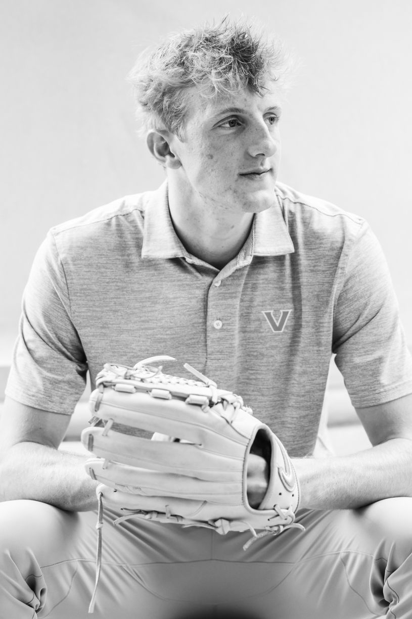 A close-up portrait shot of senior boy wearing a gray WVU polo shirt.