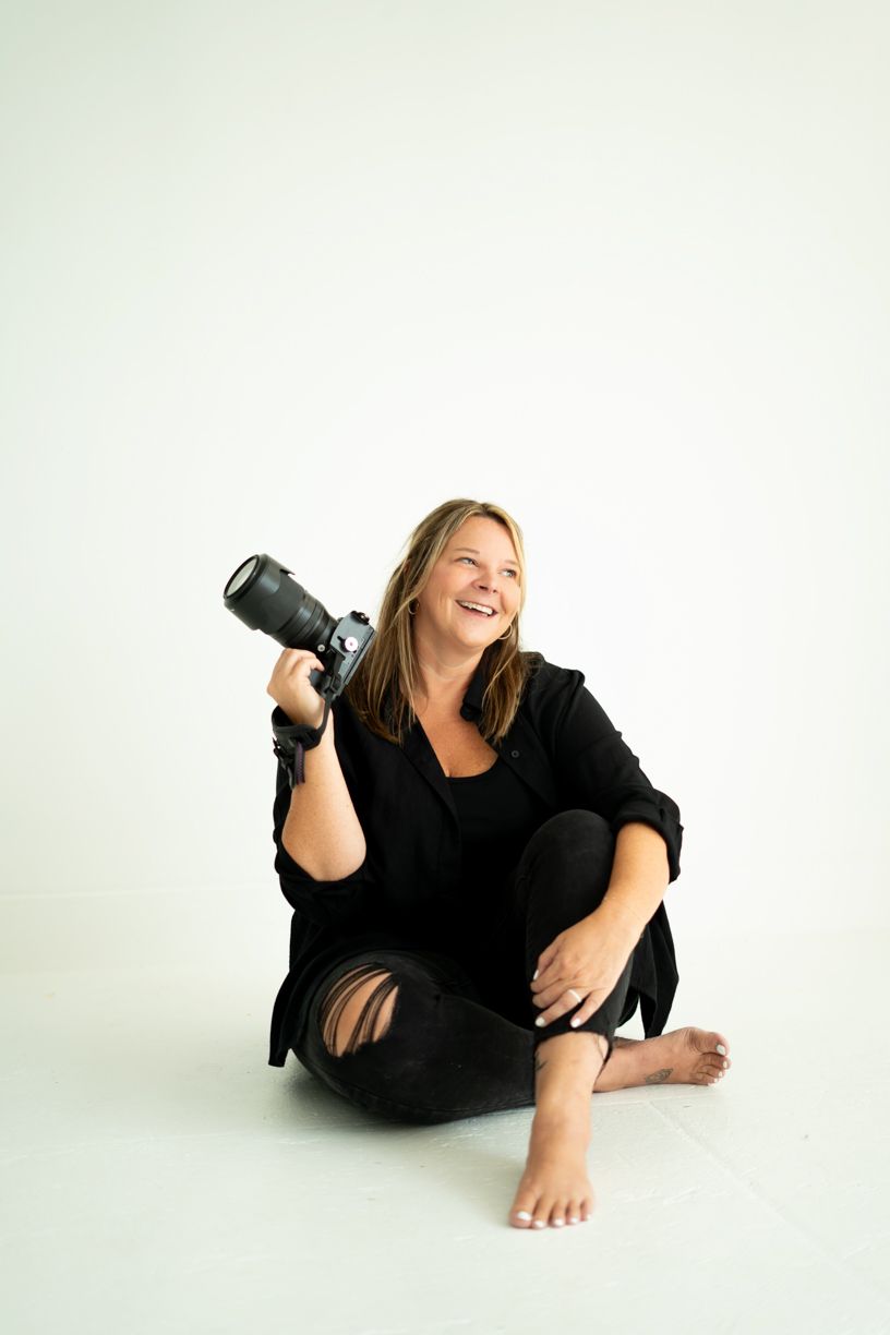 Relaxed studio photography session showing casual poses with camera equipment.