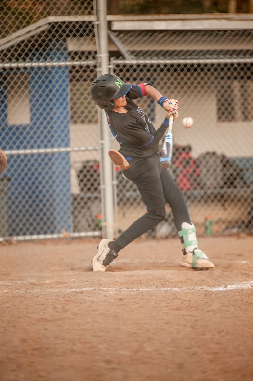 Baseball player sliding into home plate during game action sequence.