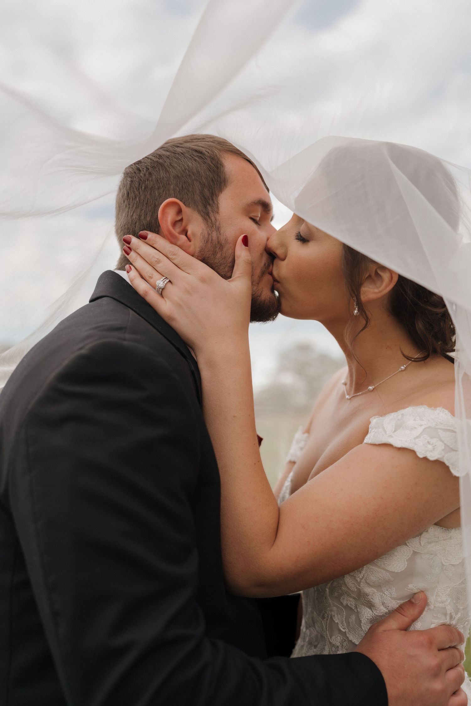 Close-up wedding photos capturing intimate kisses between newlyweds against a bright sky.  wedding, lifestyle, cinematic,