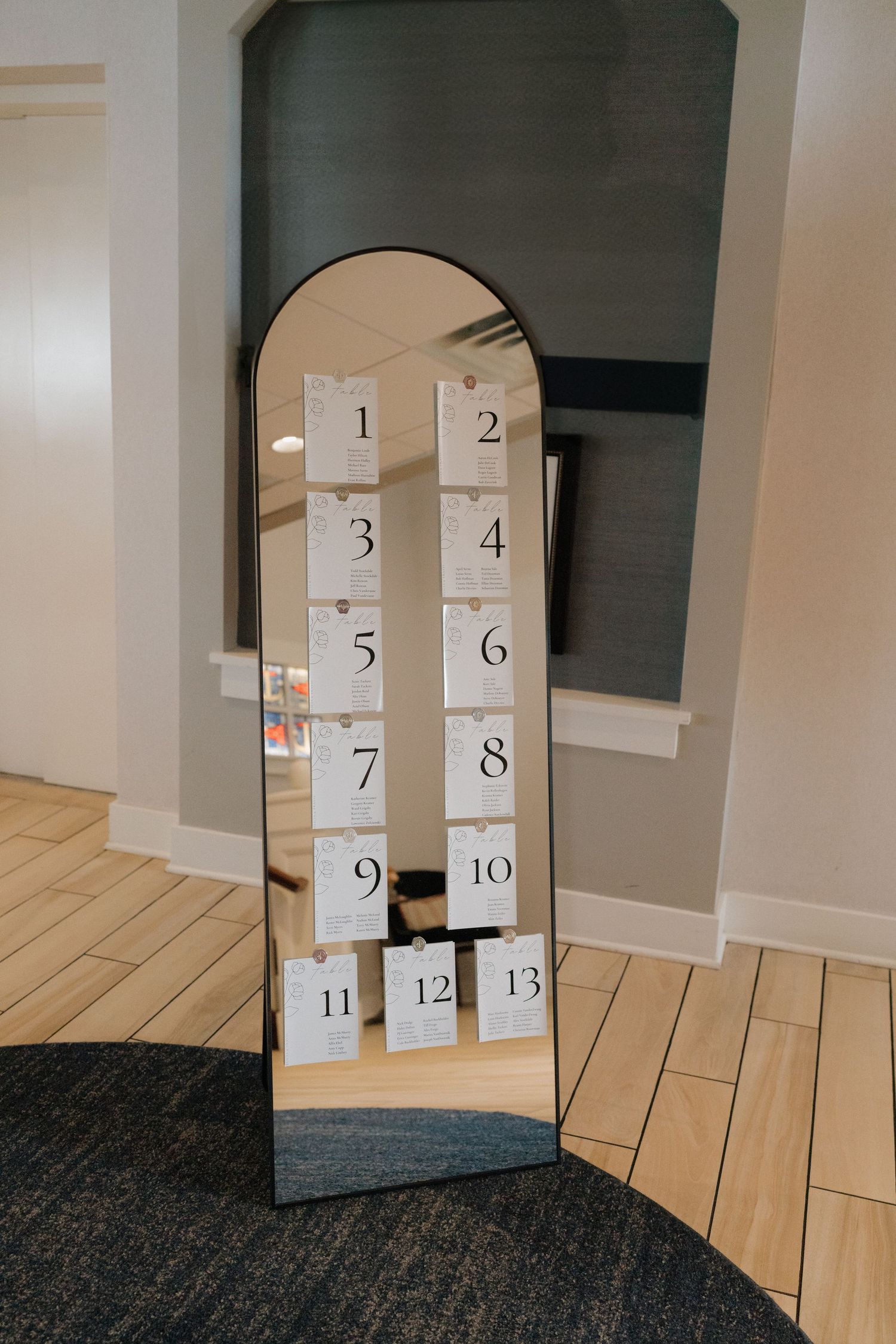 Numbered white paper bags arranged as an advent calendar against a gray wall.