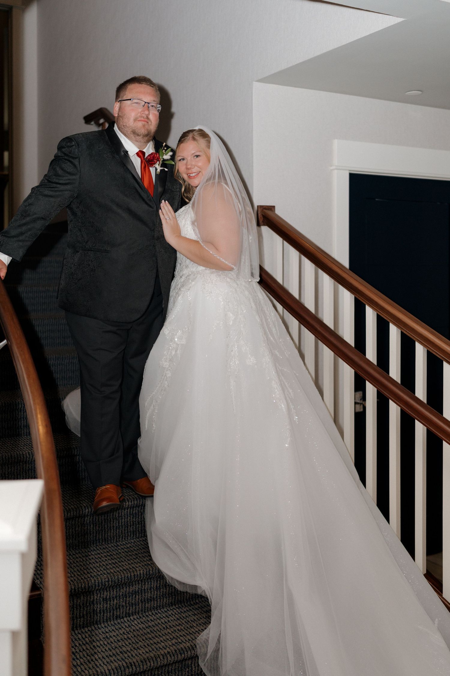 Wedding photos on a staircase showing moments between the couple.