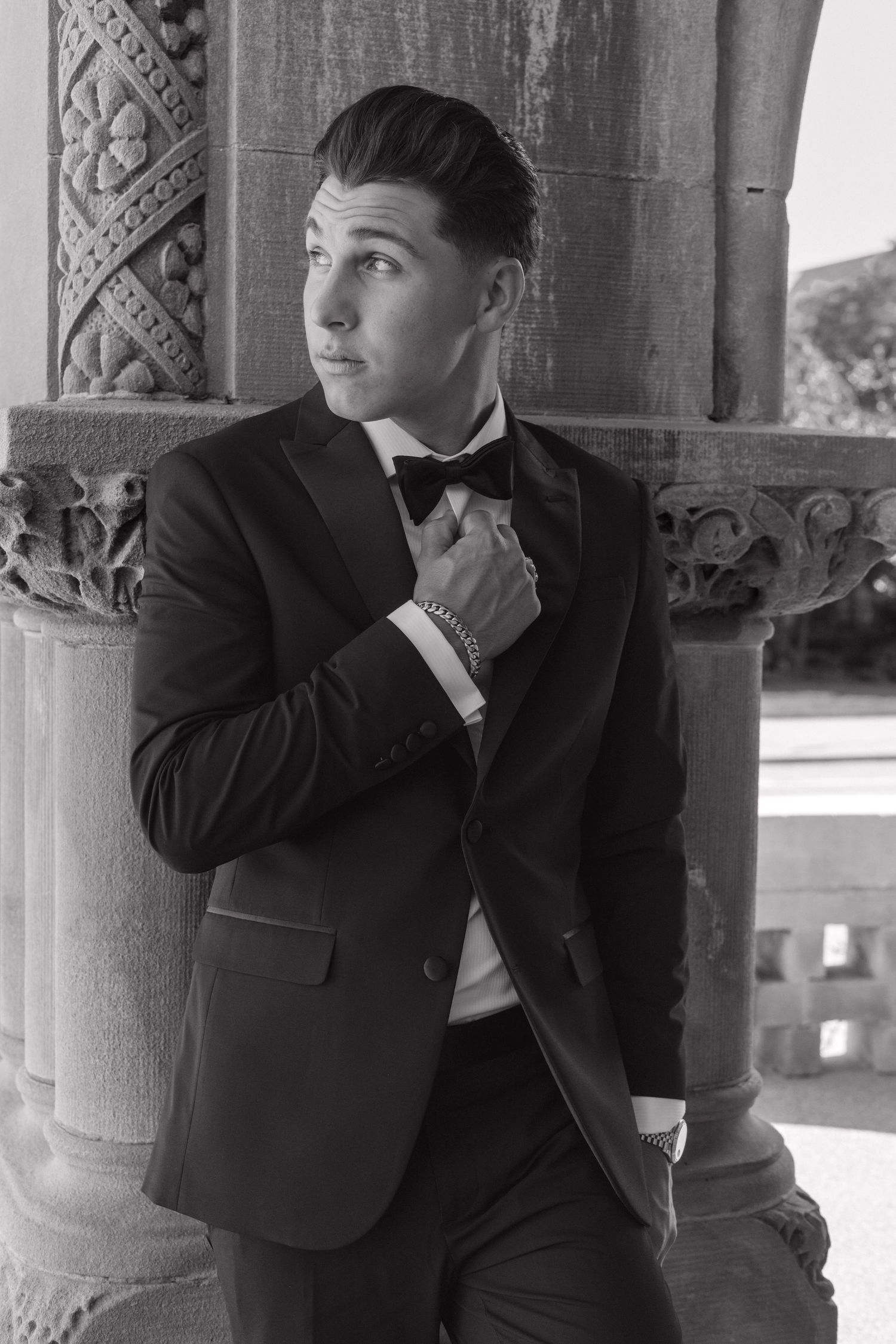 Portrait series showing contemplative poses against architectural stone columns.wedding, fortwayne, Indiana
