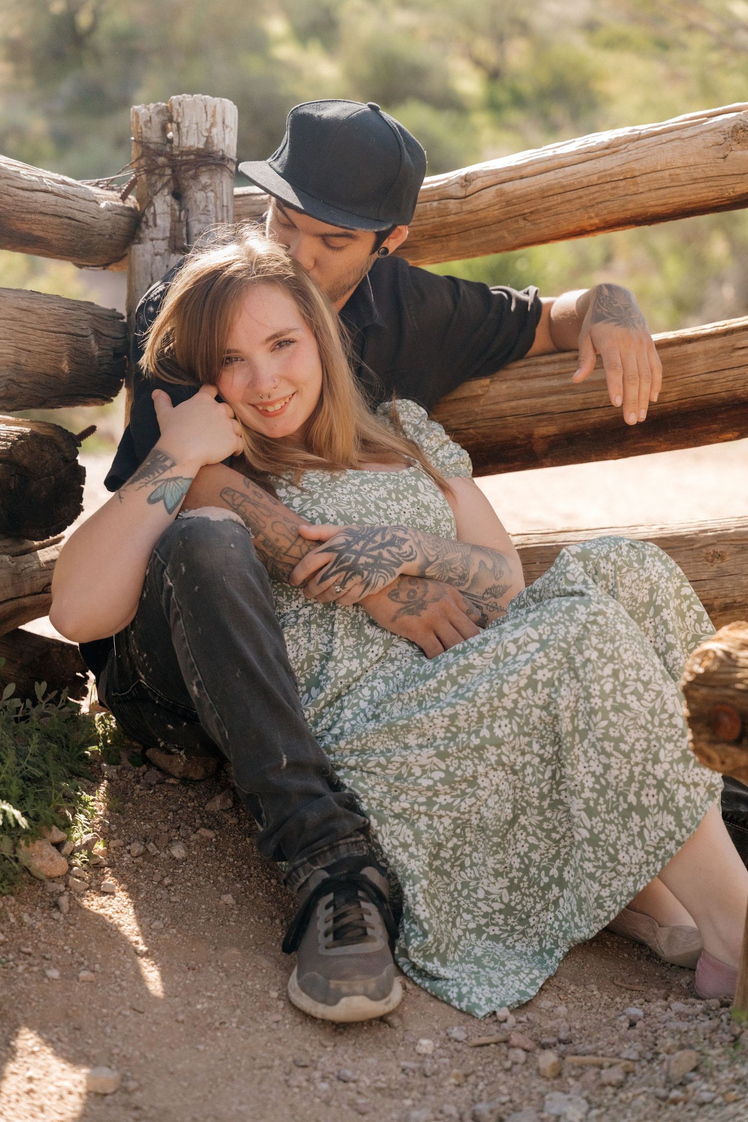 A couple relaxes together on rustic wooden logs in a romantic outdoor setting. Arizona session, cinematic
