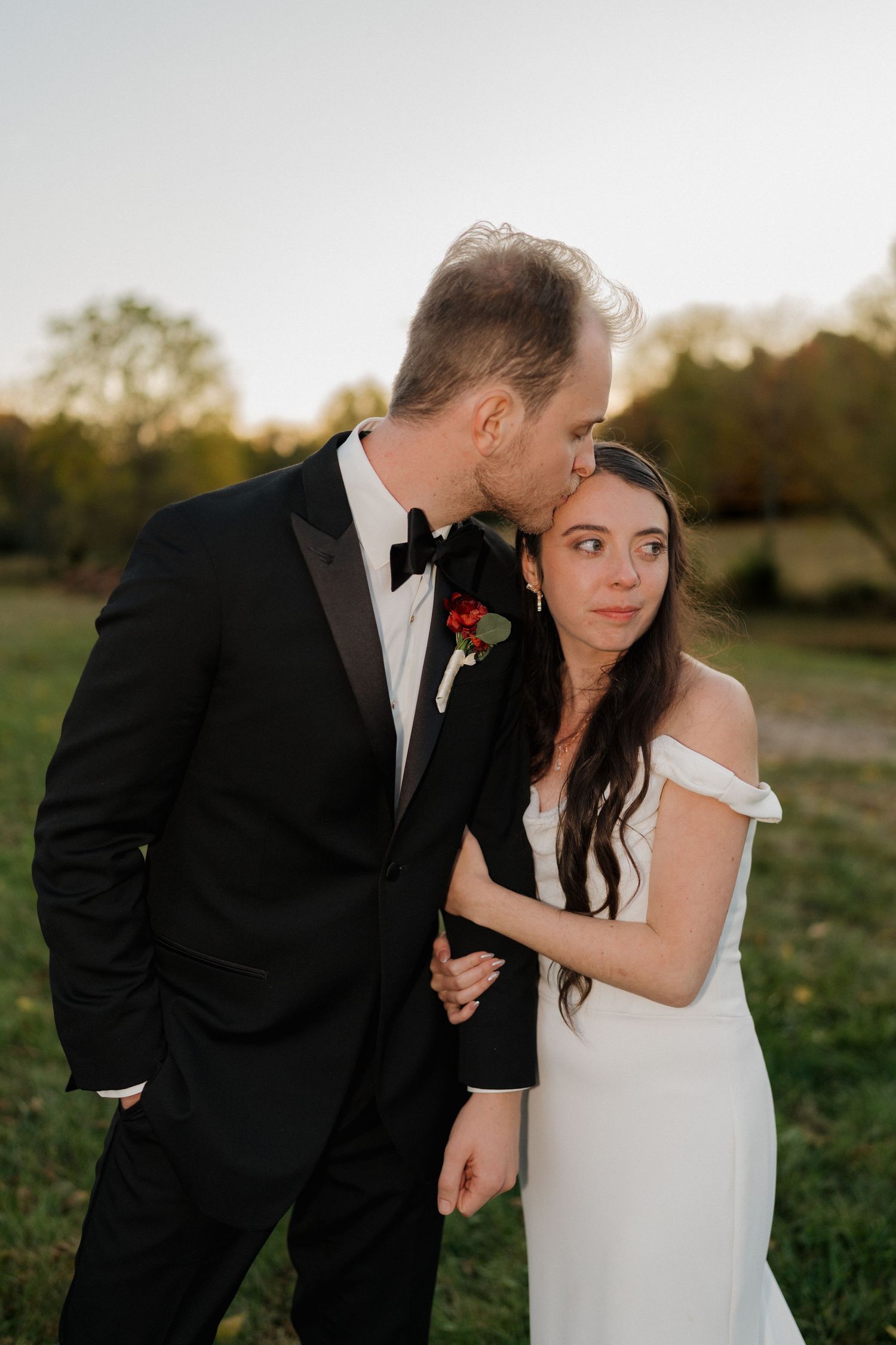Romantic outdoor wedding portrait session in a golden autumn field at sunset.