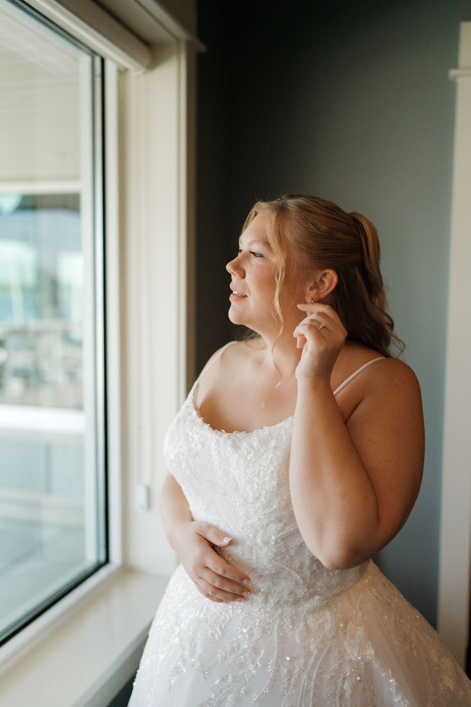 Series of photos showing a bride in a white dress looking out large windows.