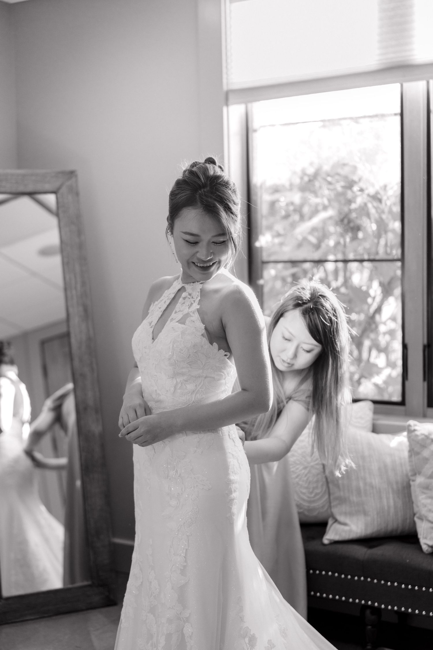 Black and white sequence showing someone trying on a wedding dress.