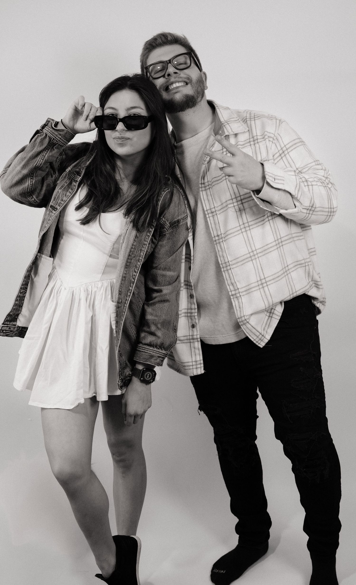 A stylish black and white studio portrait of a couple in casual outfits. branding photo, Indianapolis Indiana