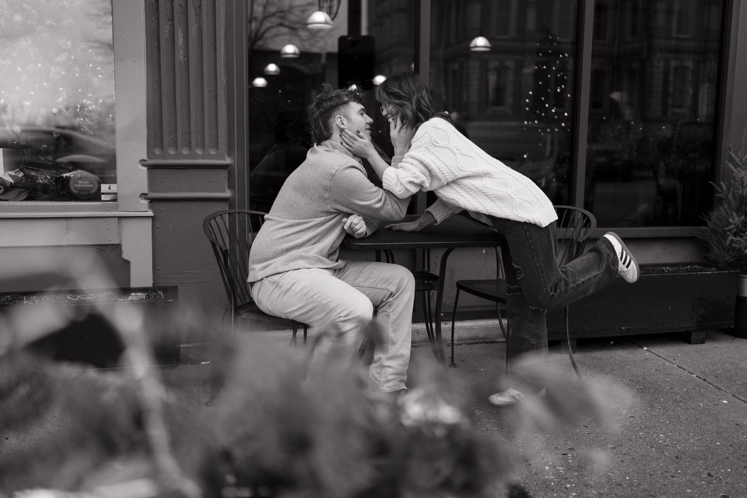 Romantic couple shares intimate moments on outdoor steps at sunset.