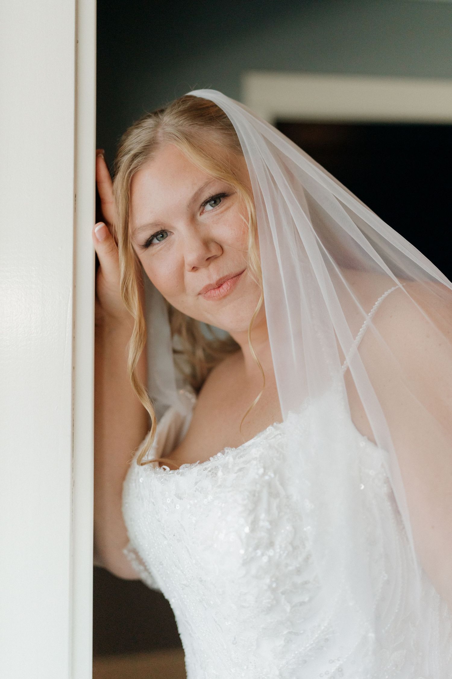 Close up shots of a wedding dress with delicate lace details and flowing white veil.
