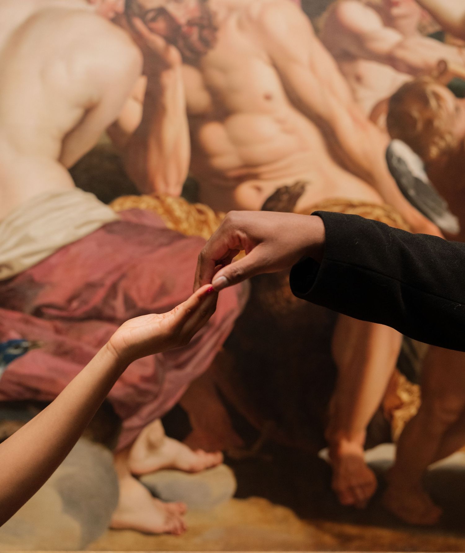 A sequence of hands grasping and holding each other in a warm, supportive gesture against a soft brown background.
