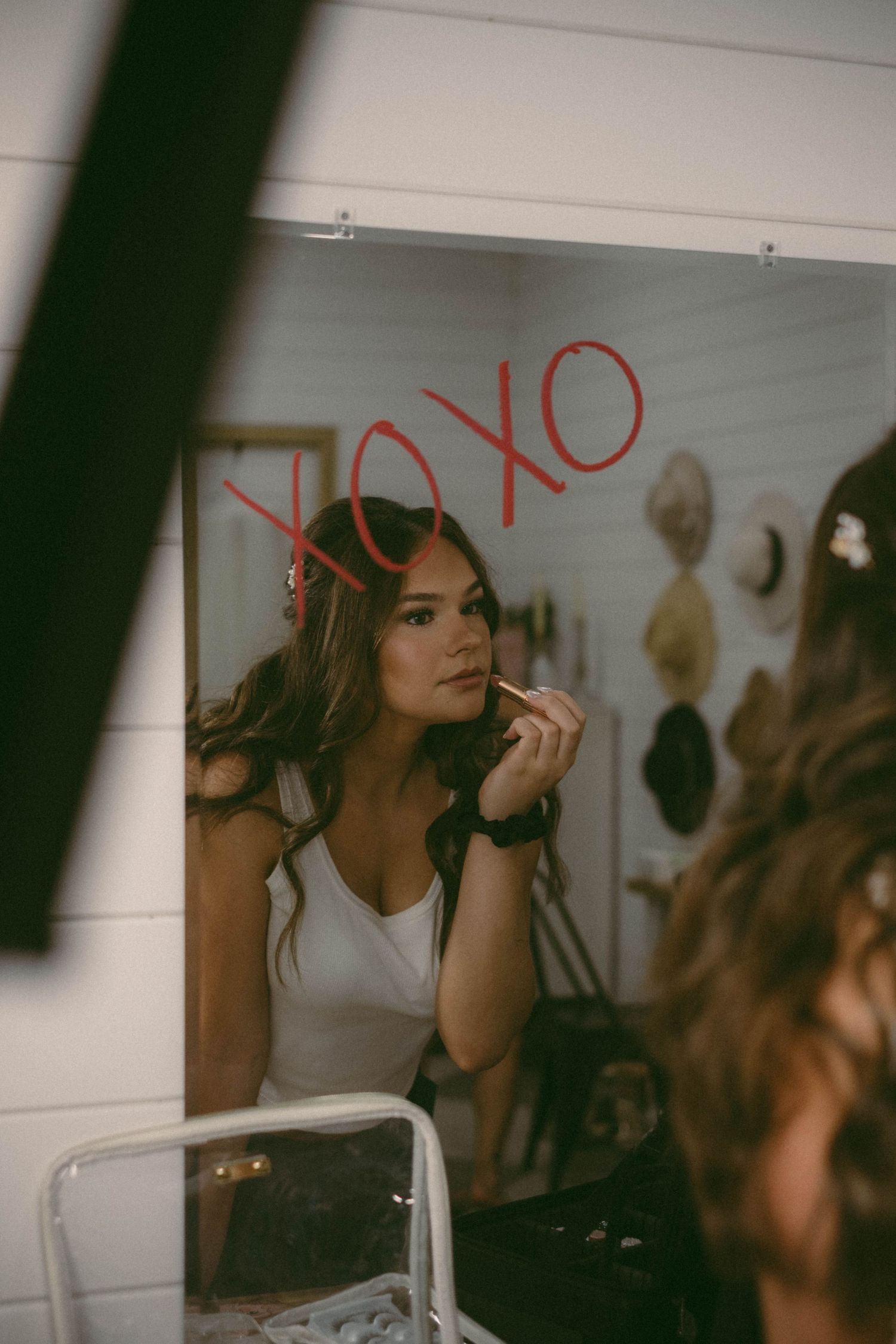 A dimly lit scene of wedding preparation with makeup being applied.