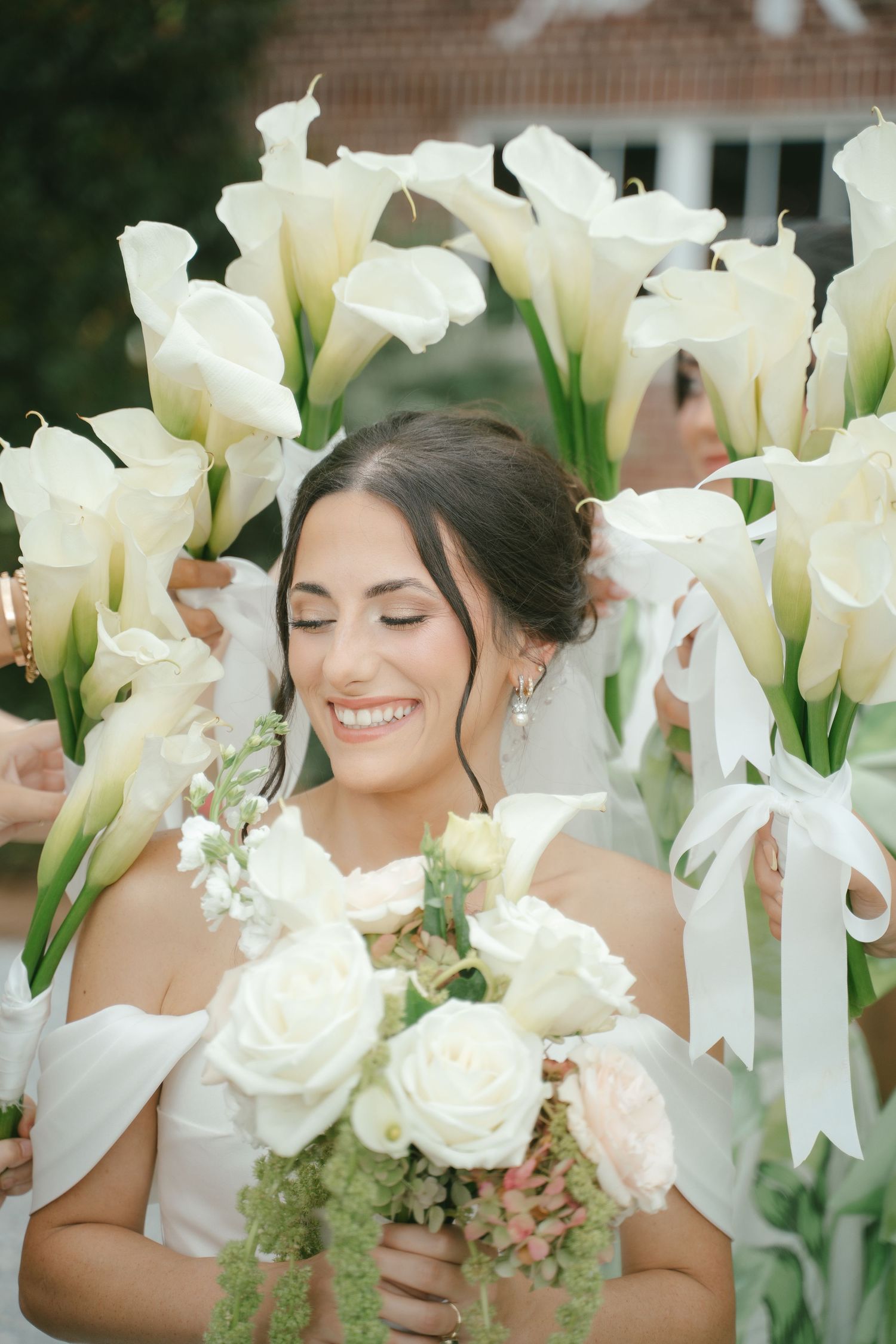 Beautiful white calla lilies and roses in bridal bouquet arrangement.
