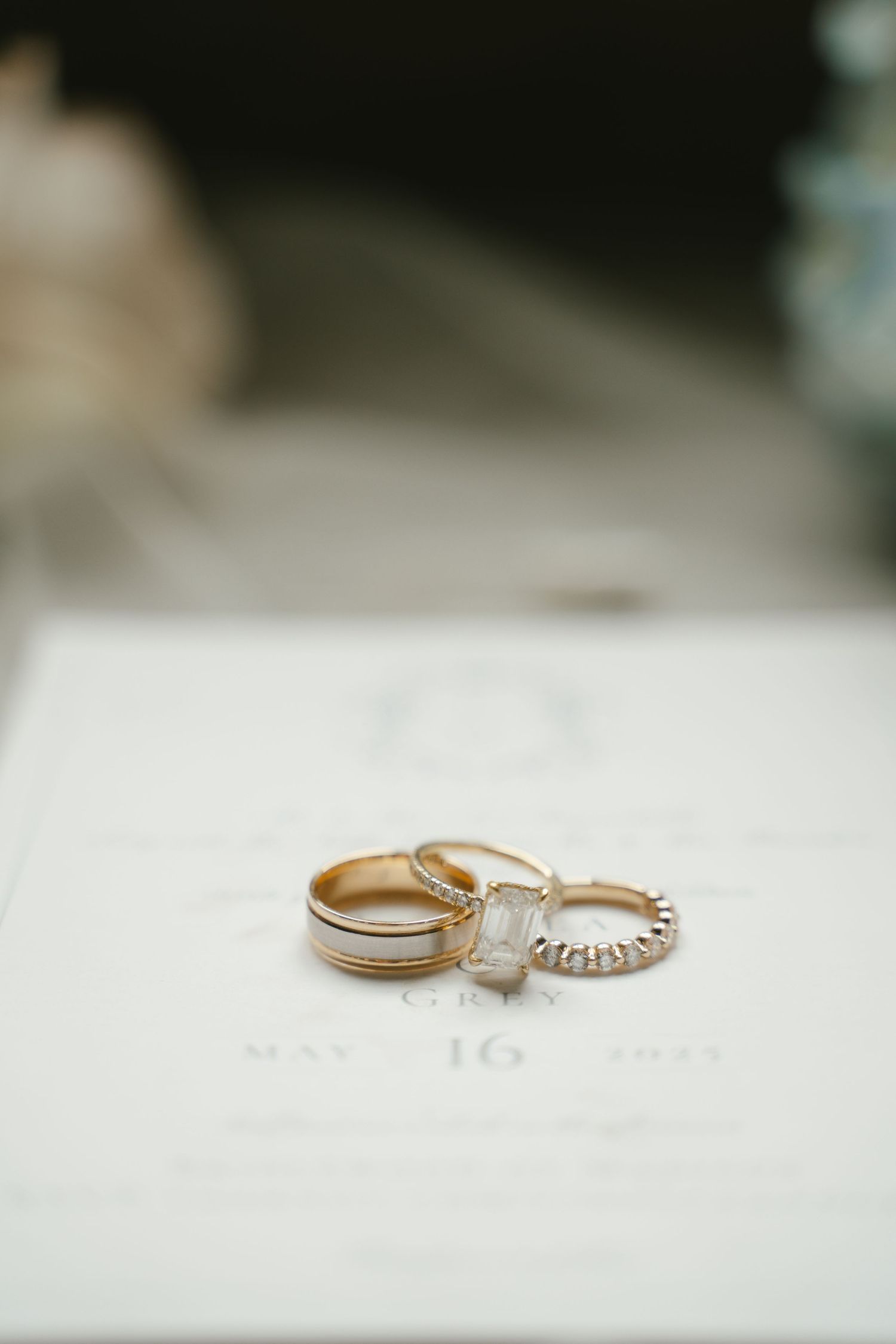 Wedding rings displayed on white surface showing intricate diamond details.