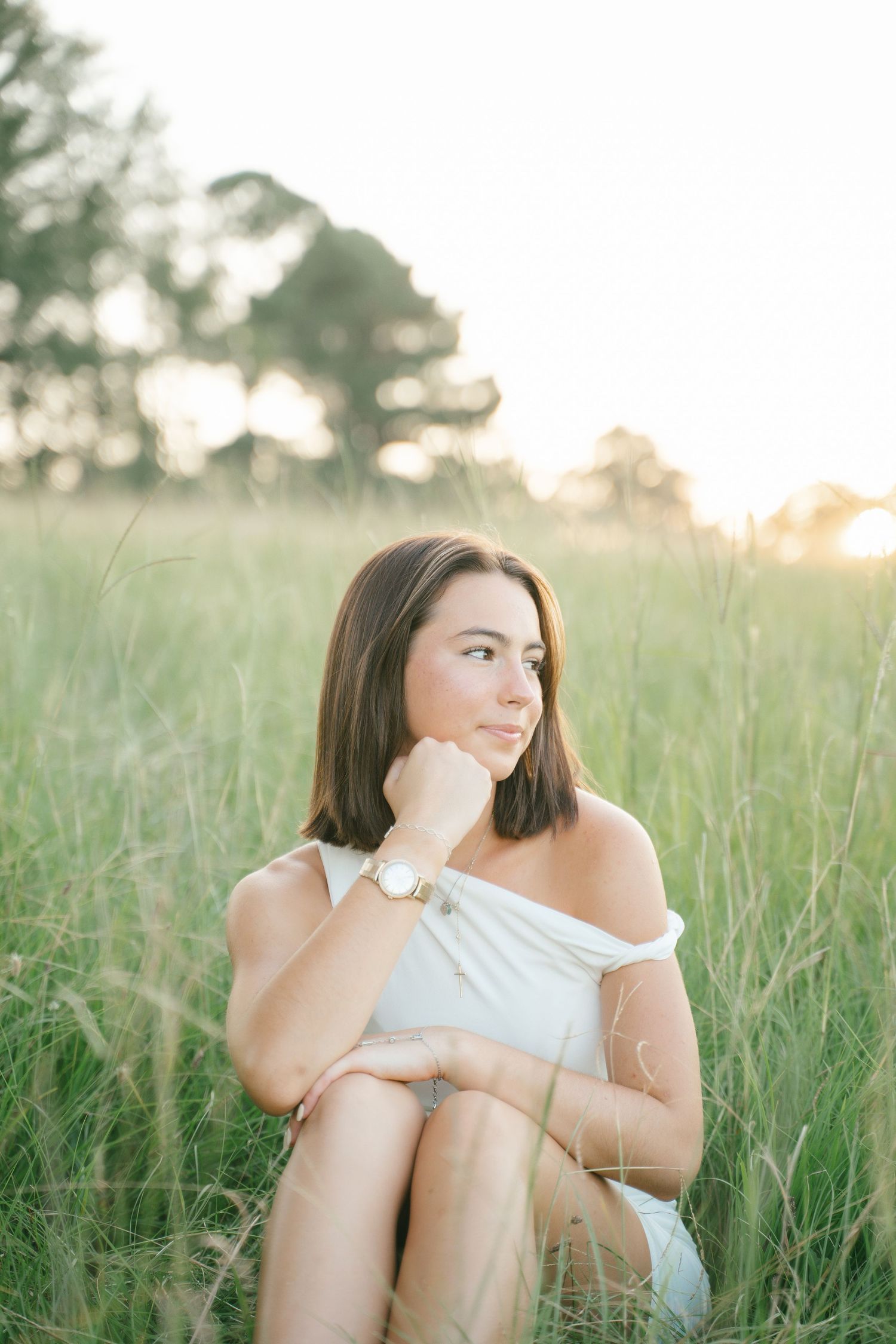 Dreamy summer portrait in tall grass during golden hour.