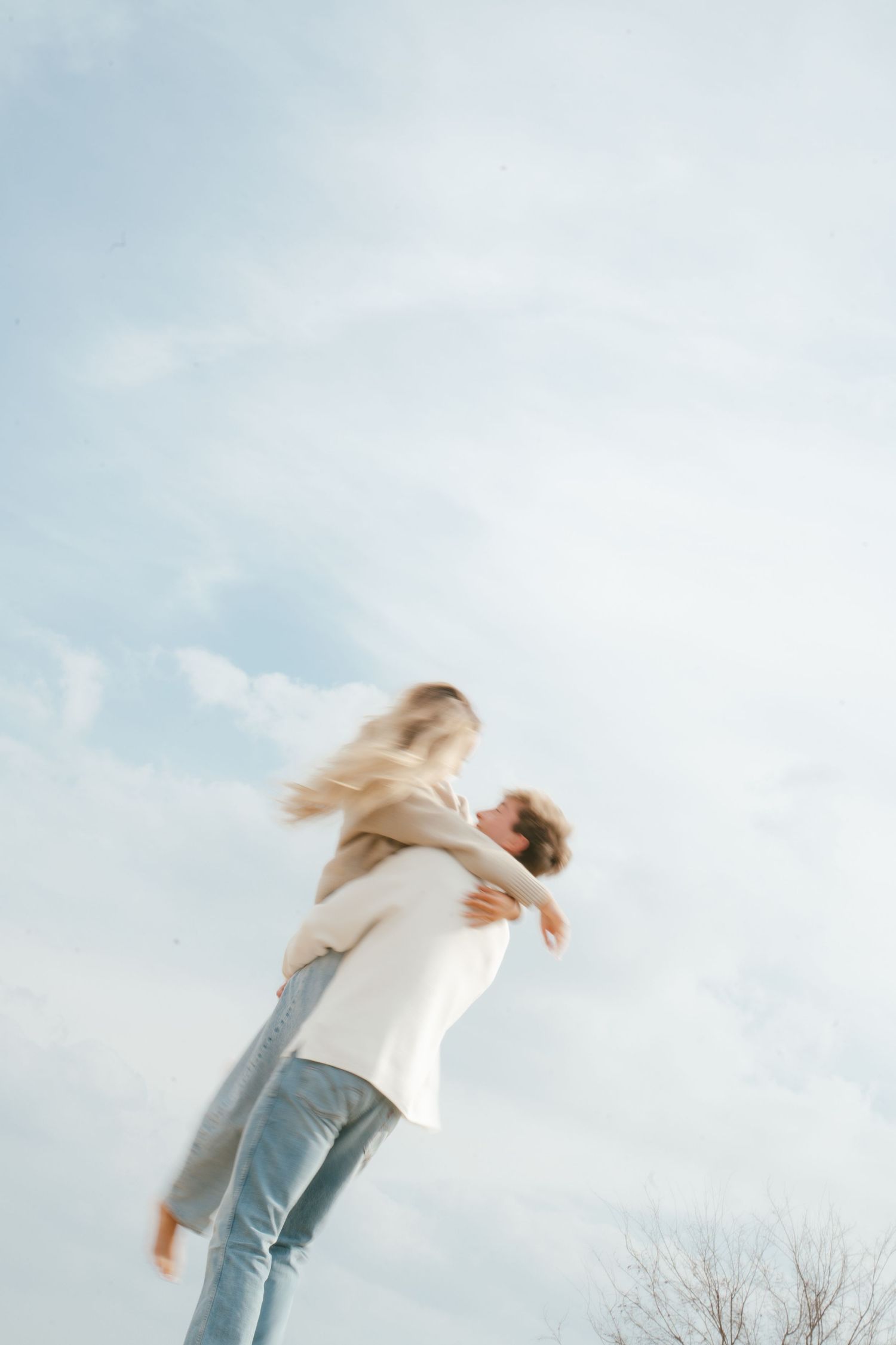 A sequence of artistic photos showing a person falling backwards against a cloudy sky background.