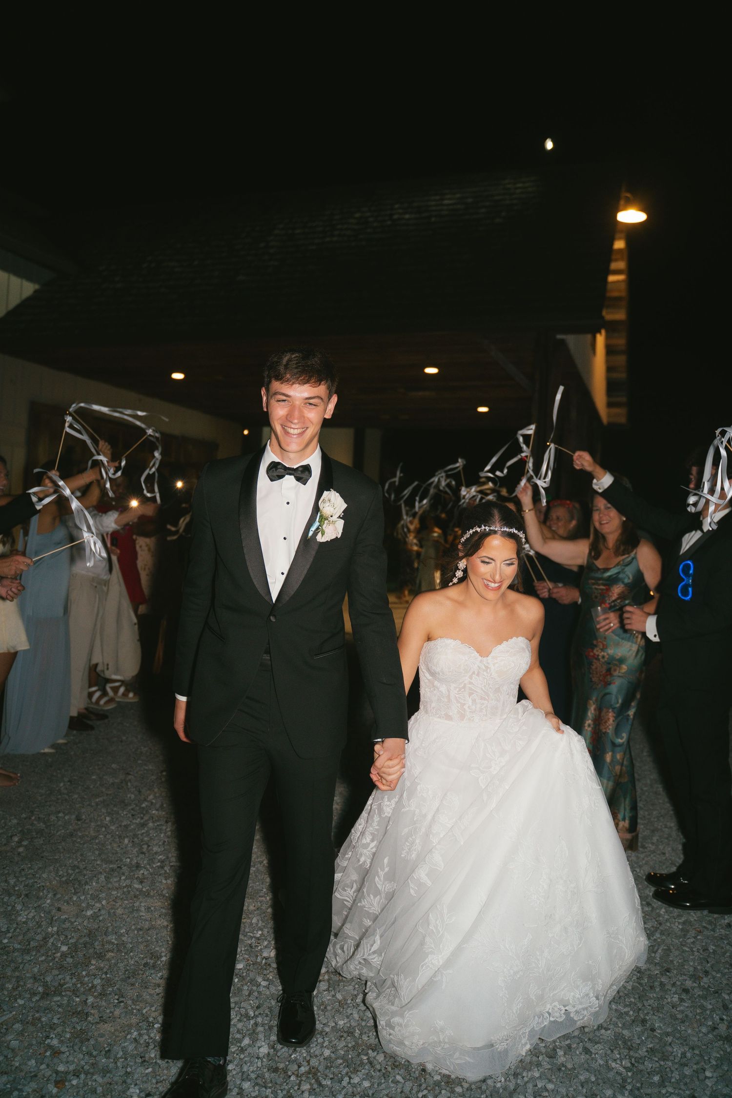 Newlyweds walking through a sparkler exit tunnel during their wedding reception.