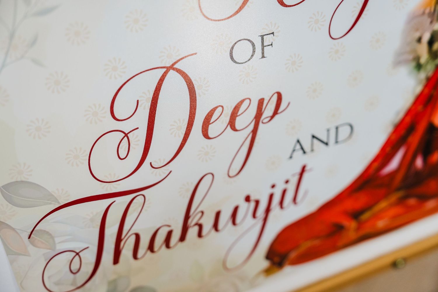 Elegant red calligraphy text showing 'Deep Thakurjit' on white paper in ornate cursive writing style.
