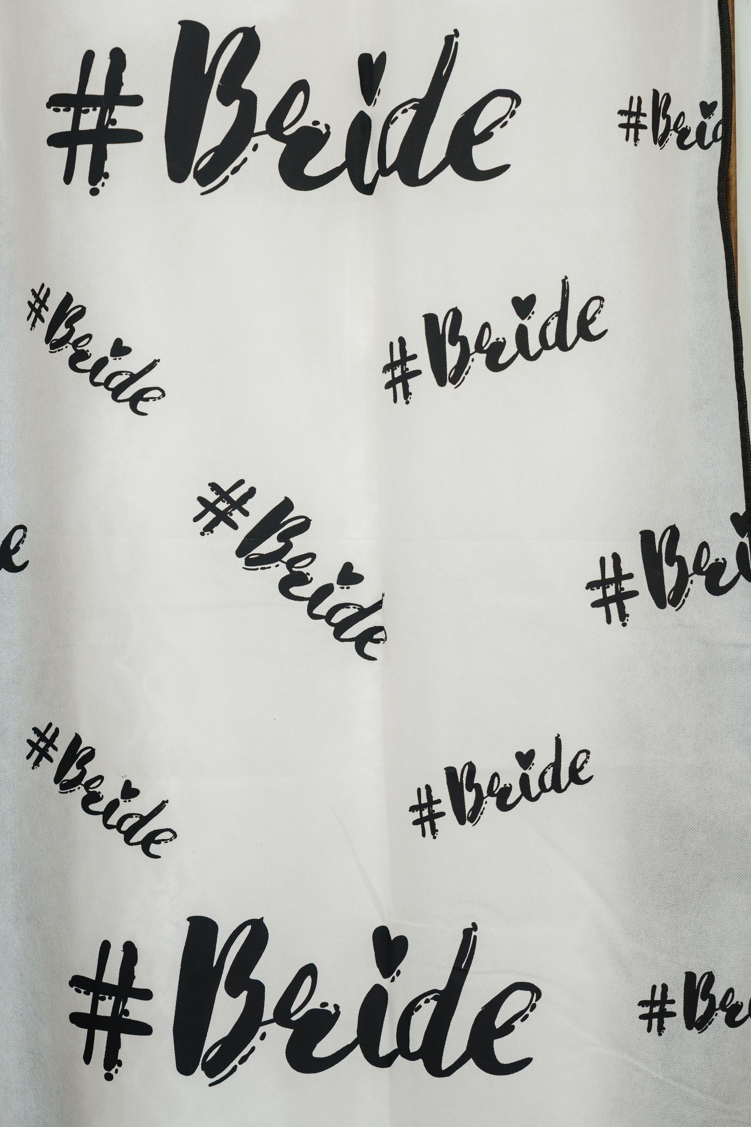 Black and white pattern of '#Bride' hashtag text repeated in brush script typography on light background.
