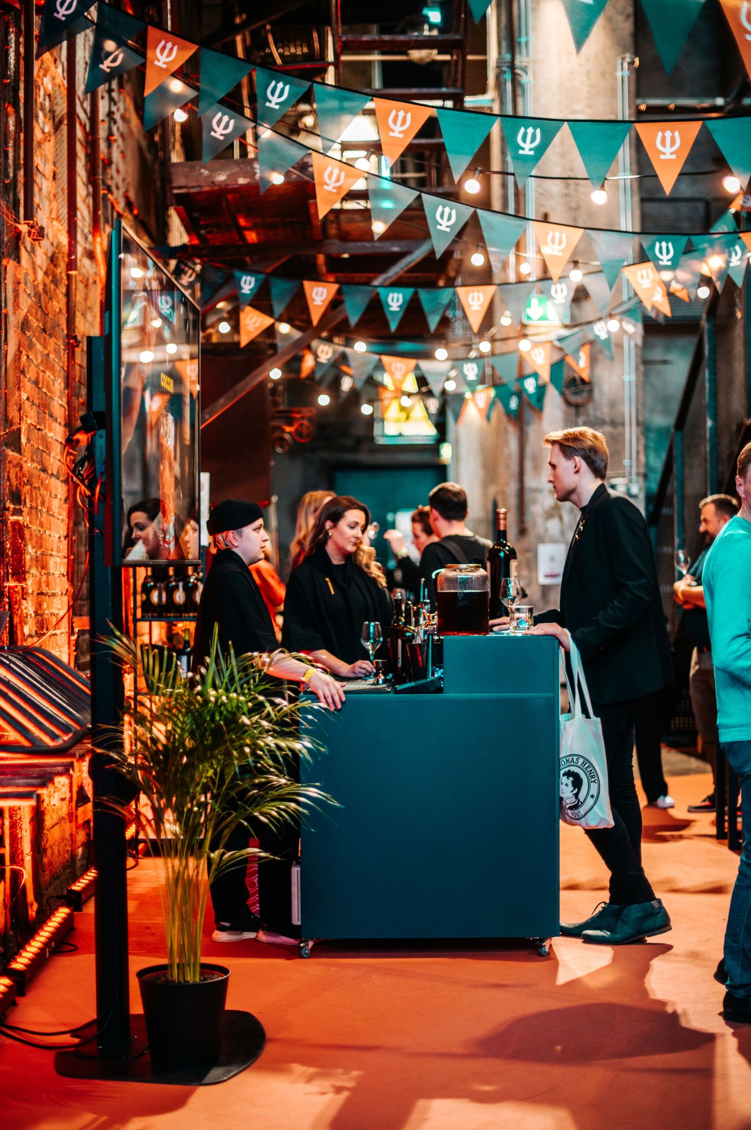 Event space decorated with colorful bunting and string lights creating a festive atmosphere.