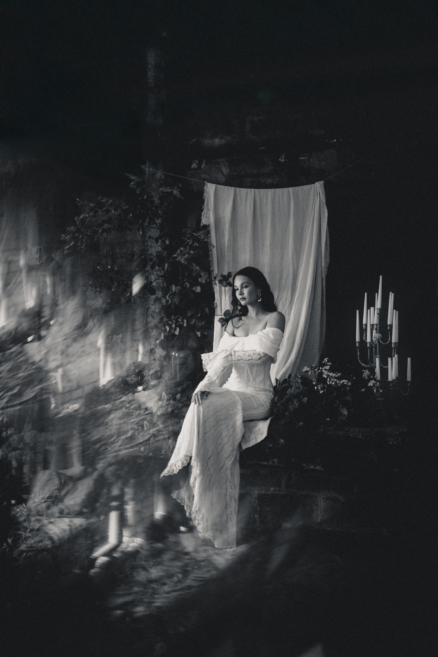 Artistic black and white bridal photos with dramatic lighting and flowing fabric.