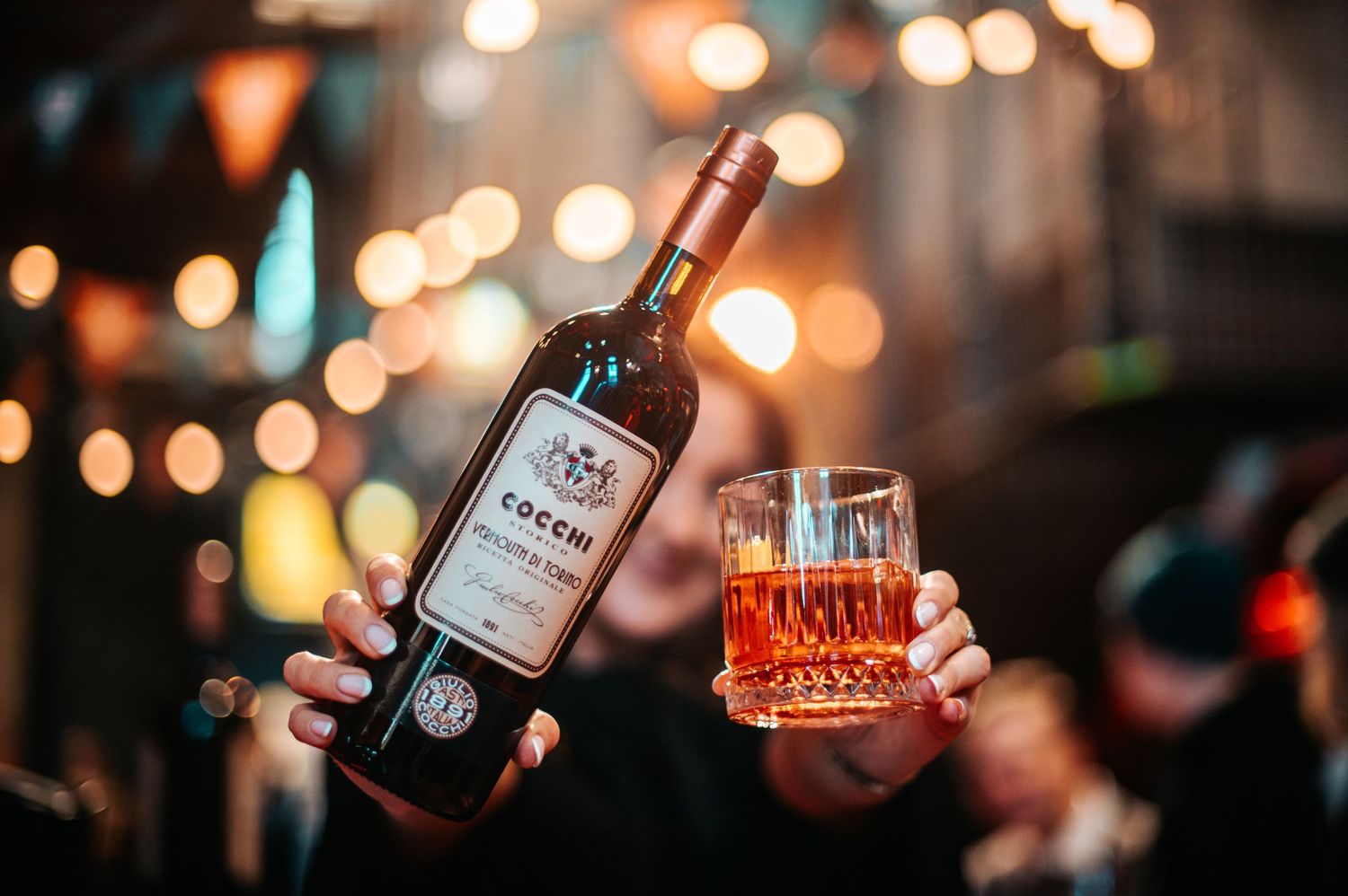 Artistically lit bottles of spirits against a bokeh background.