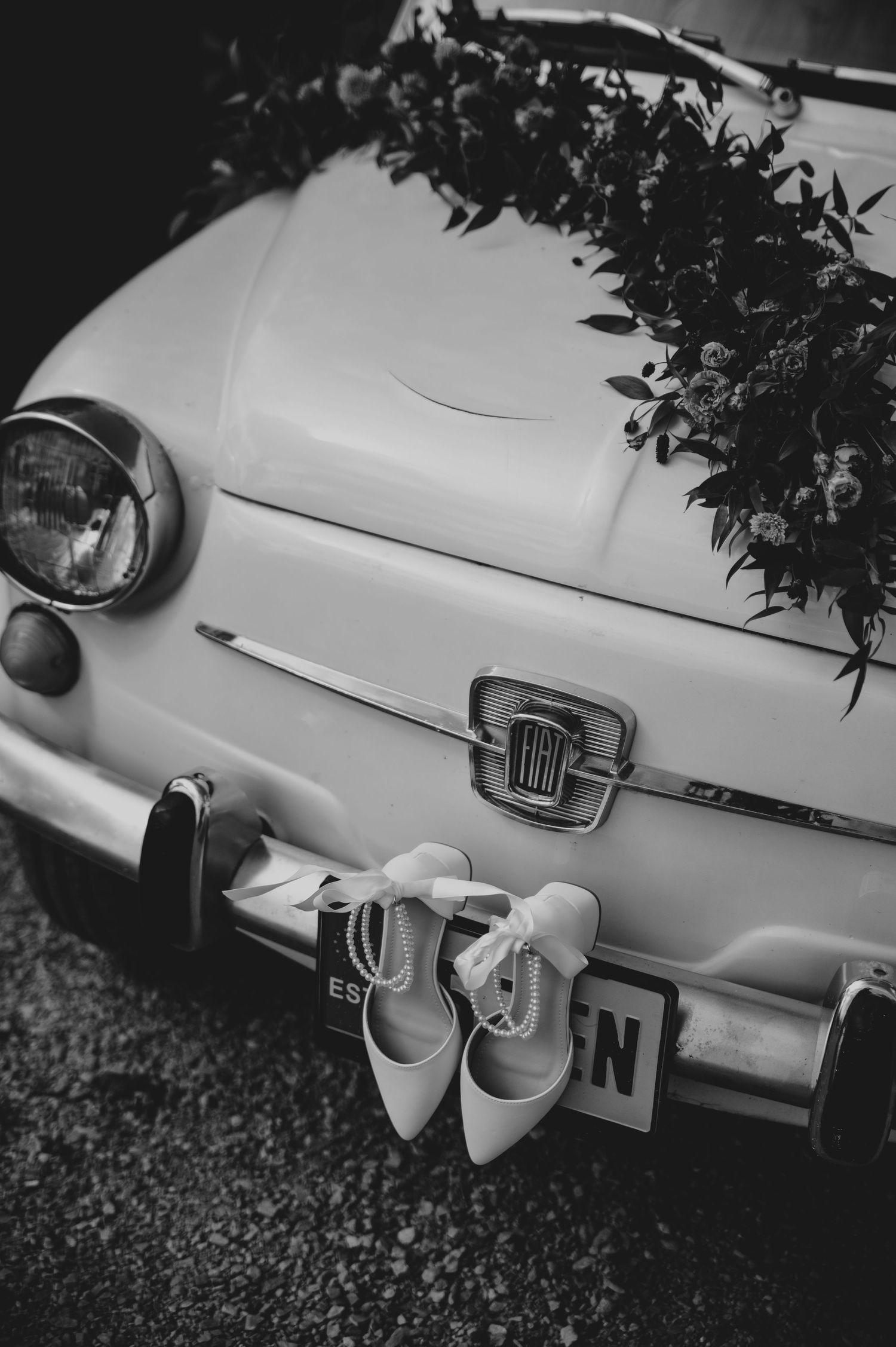 Vintage Fiat car details shown in black and white photography with artistic close-up shots of the vehicle's exterior.