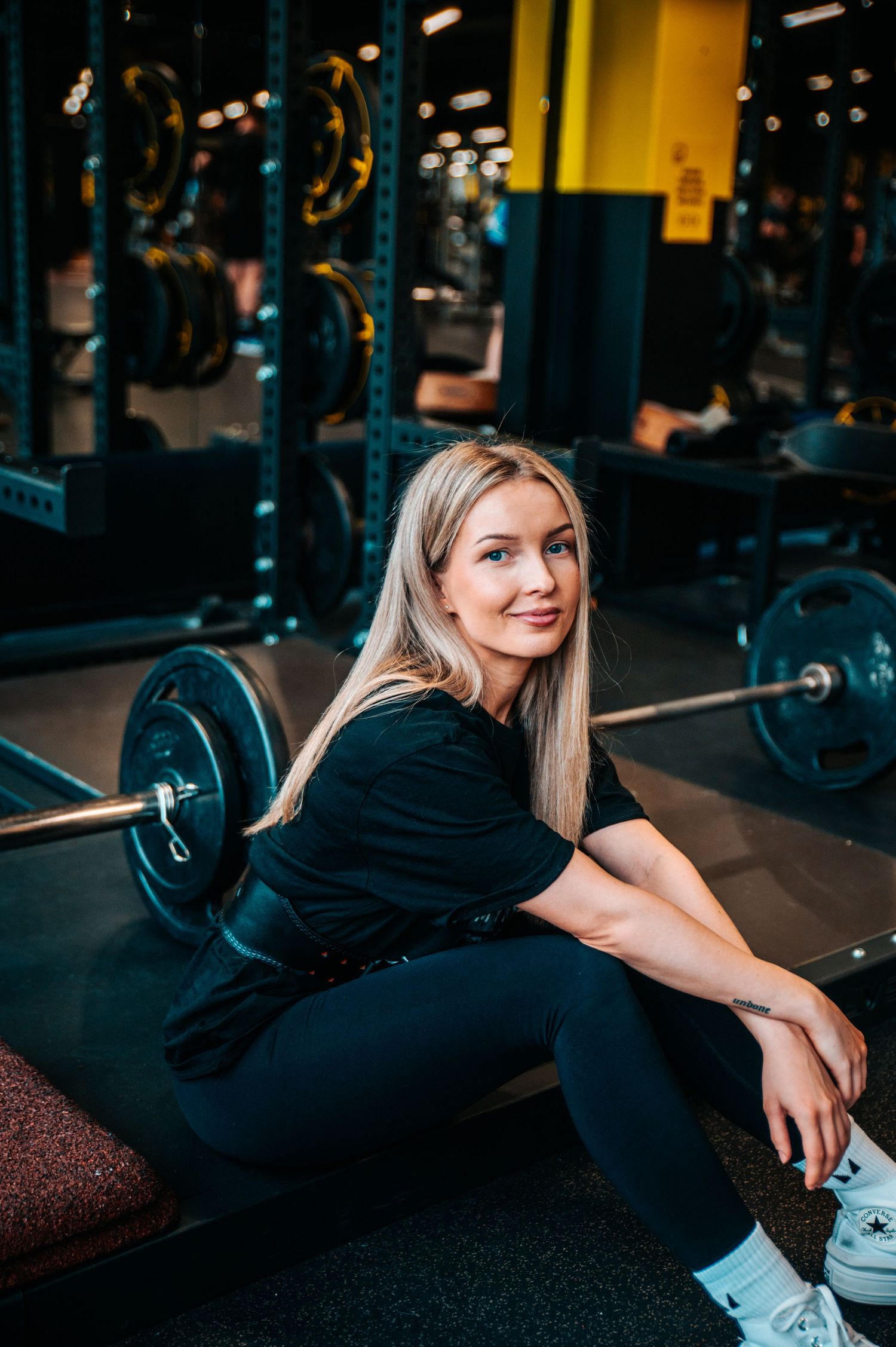 Athletic photoshoot series in a gym setting with workout equipment.