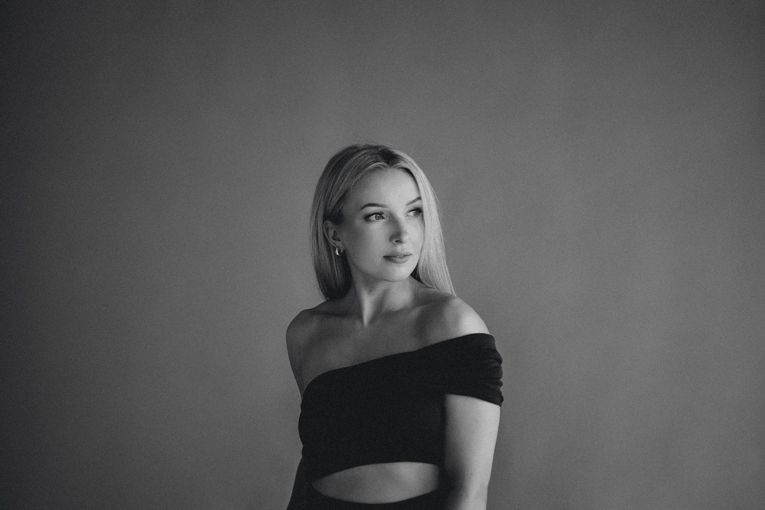 Artistic black and white portrait series with dramatic lighting and shadows.