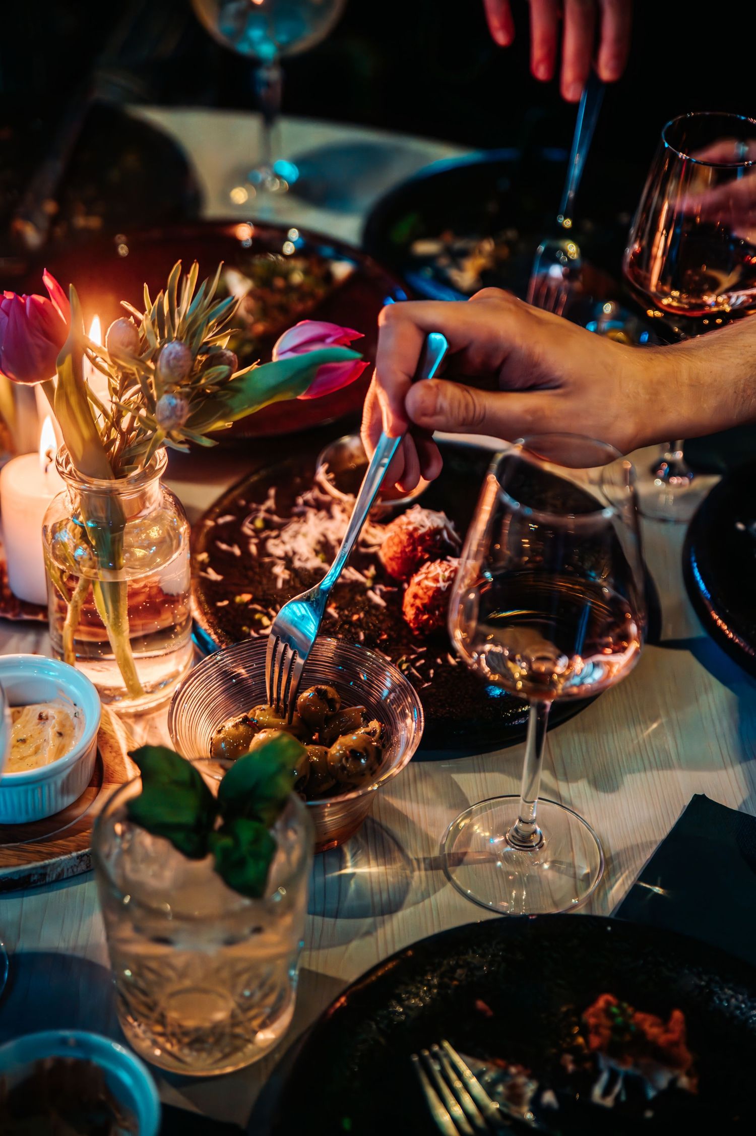 Elegant dinner table setting with wine glasses and ambient lighting.