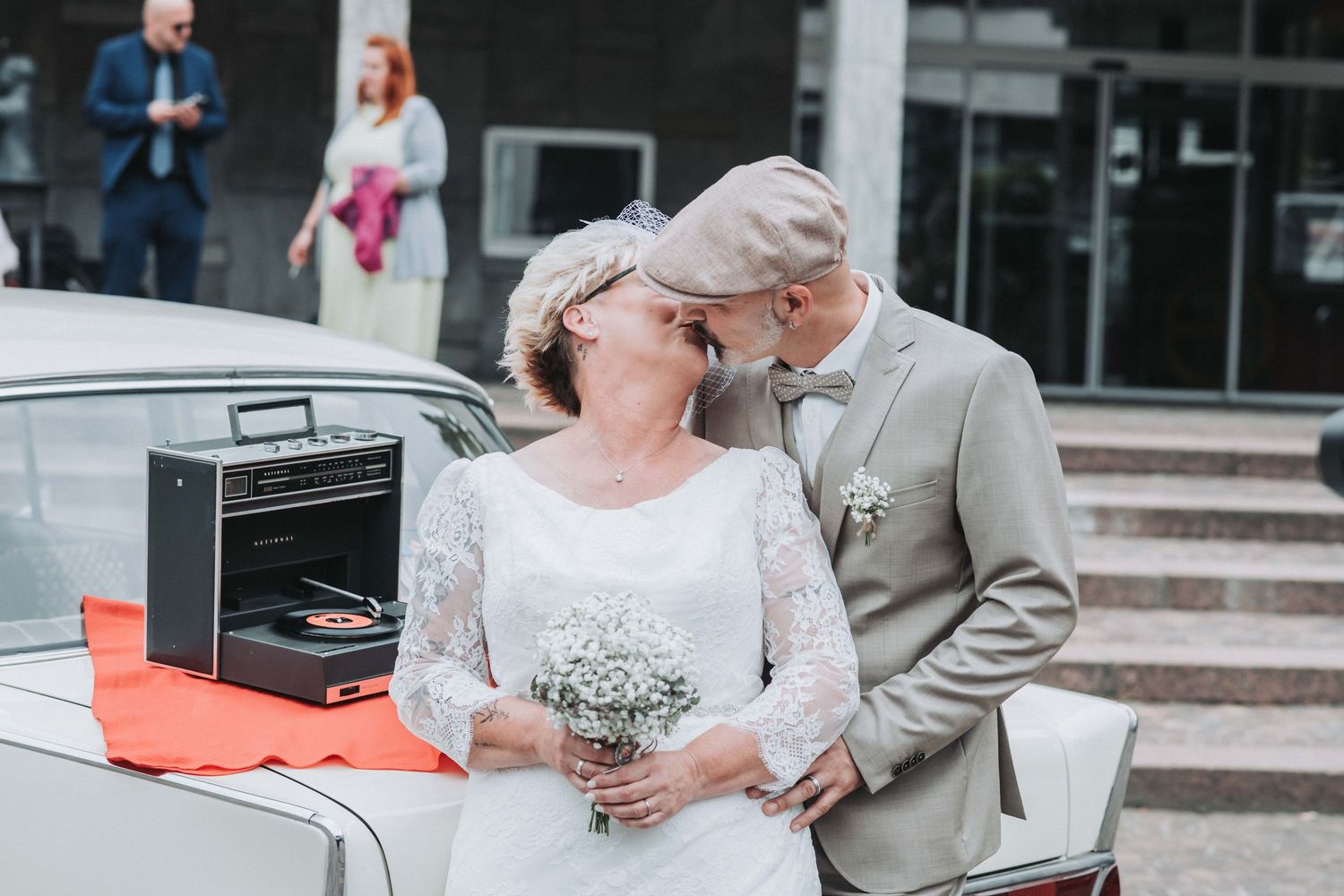 A bride and groom share a romantic moment on stone steps during their outdoor wedding ceremony.