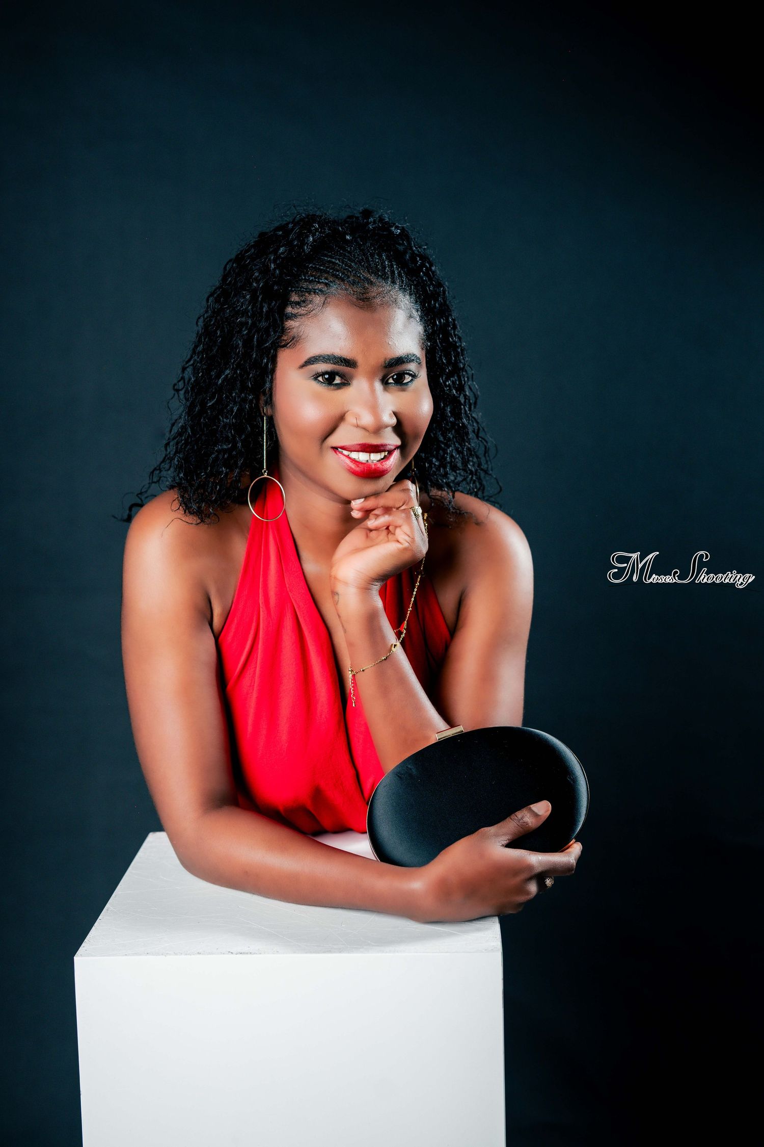 Studio portrait series showing a person in a vibrant red top posing expressively against a dark background with white props.