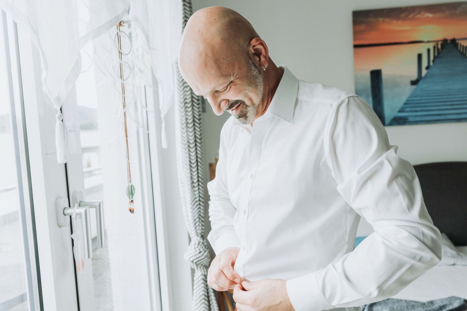 Chef in white uniform carefully prepares food in professional kitchen setting.