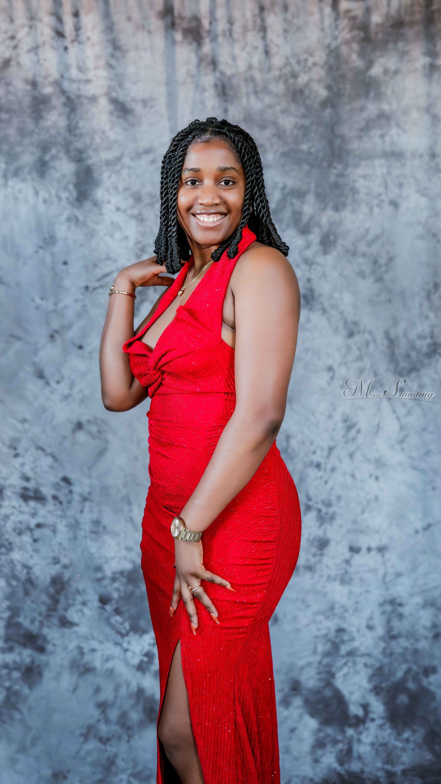 A glamorous photo series showing poses in a stunning red formal dress against a textured gray backdrop.