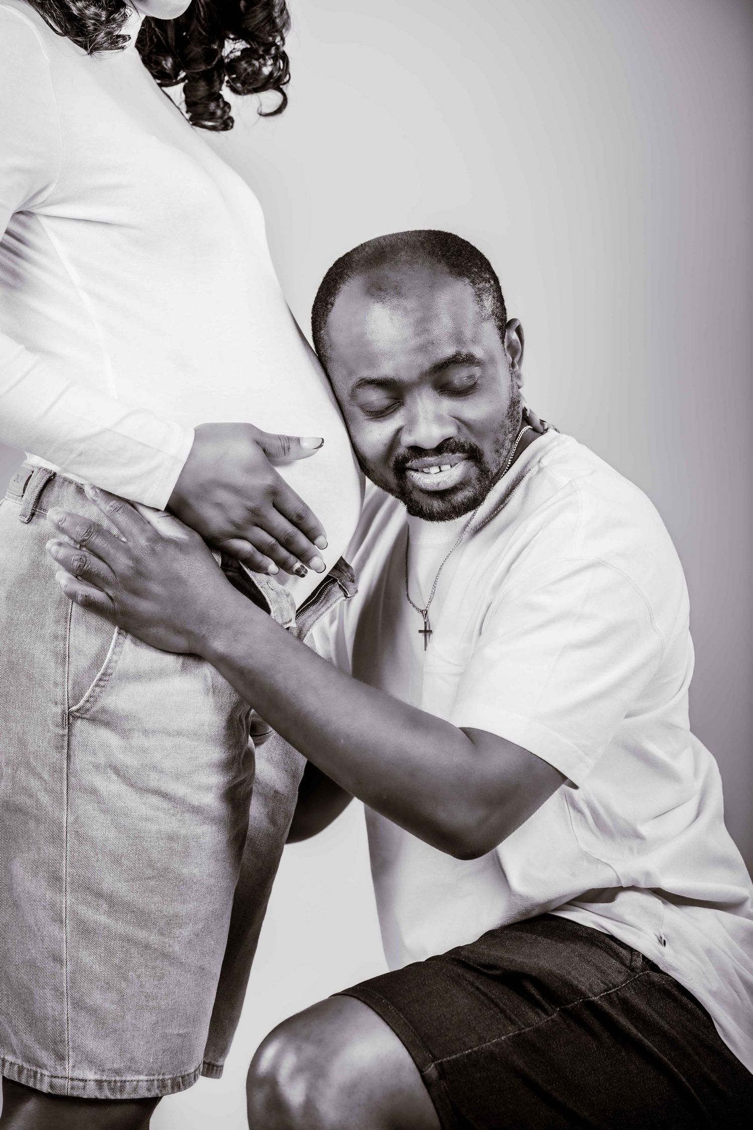 A sequence of black and white photos showing a person in a white shirt expressing joyful laughter.