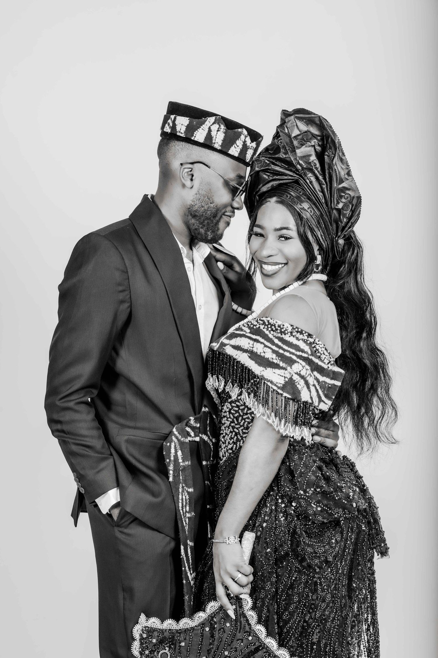 A romantic black and white photo series showing a couple embracing and sharing intimate moments together.