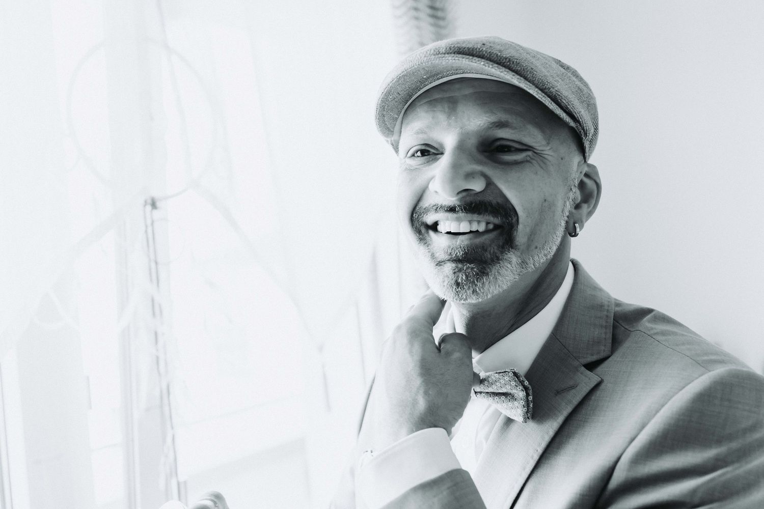 A black and white photo collage shows someone smiling and posing in different expressions and angles.