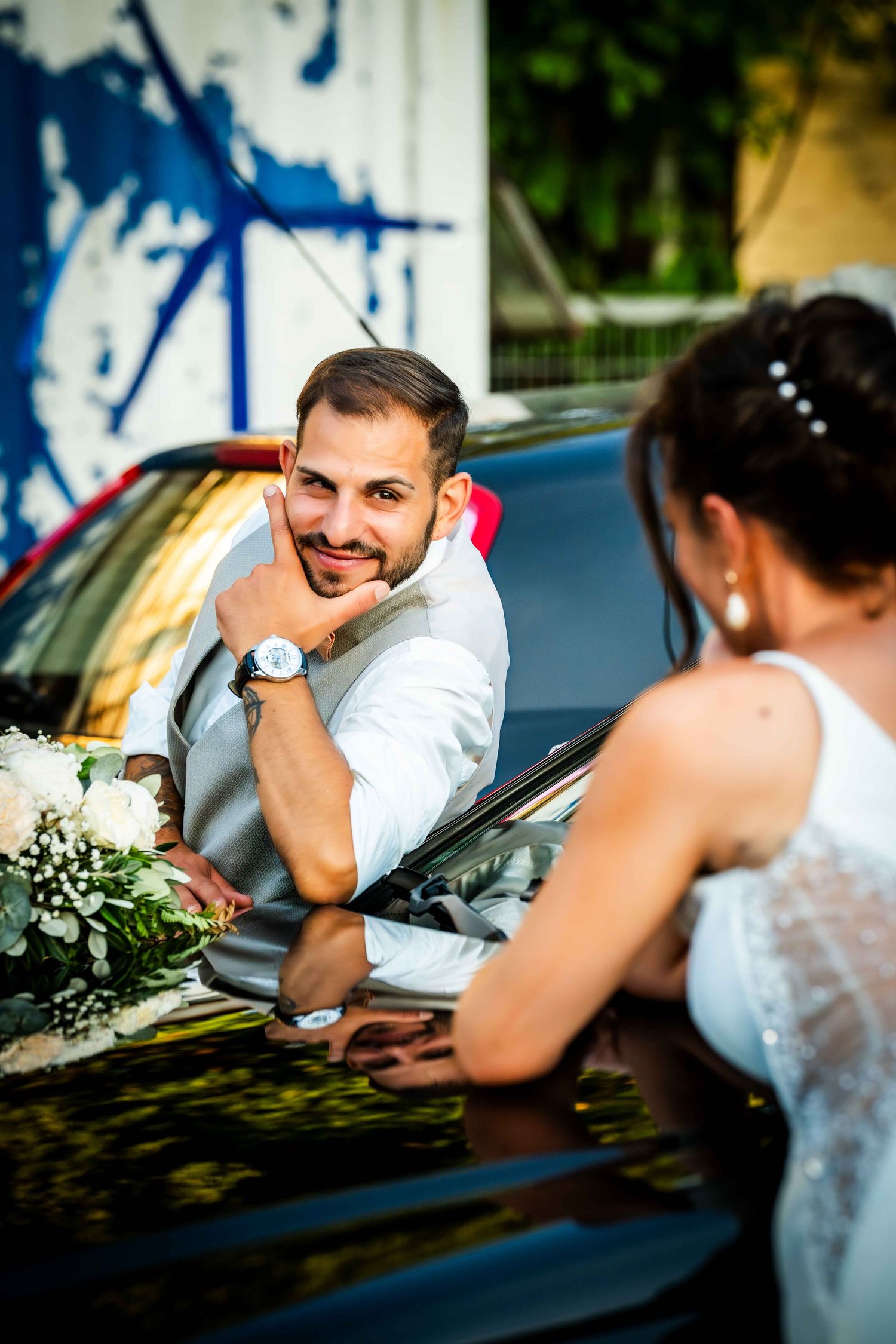 A sequence of wedding photos capturing playful interactions between a couple near a vintage car.