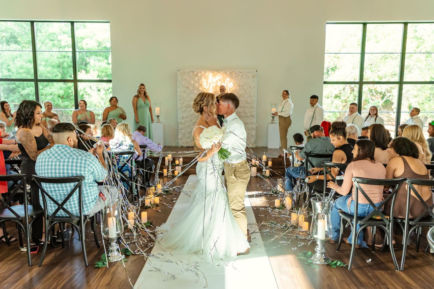 brides share aisle kiss at sorelle in Thomas Oklahoma after their wedding vows.