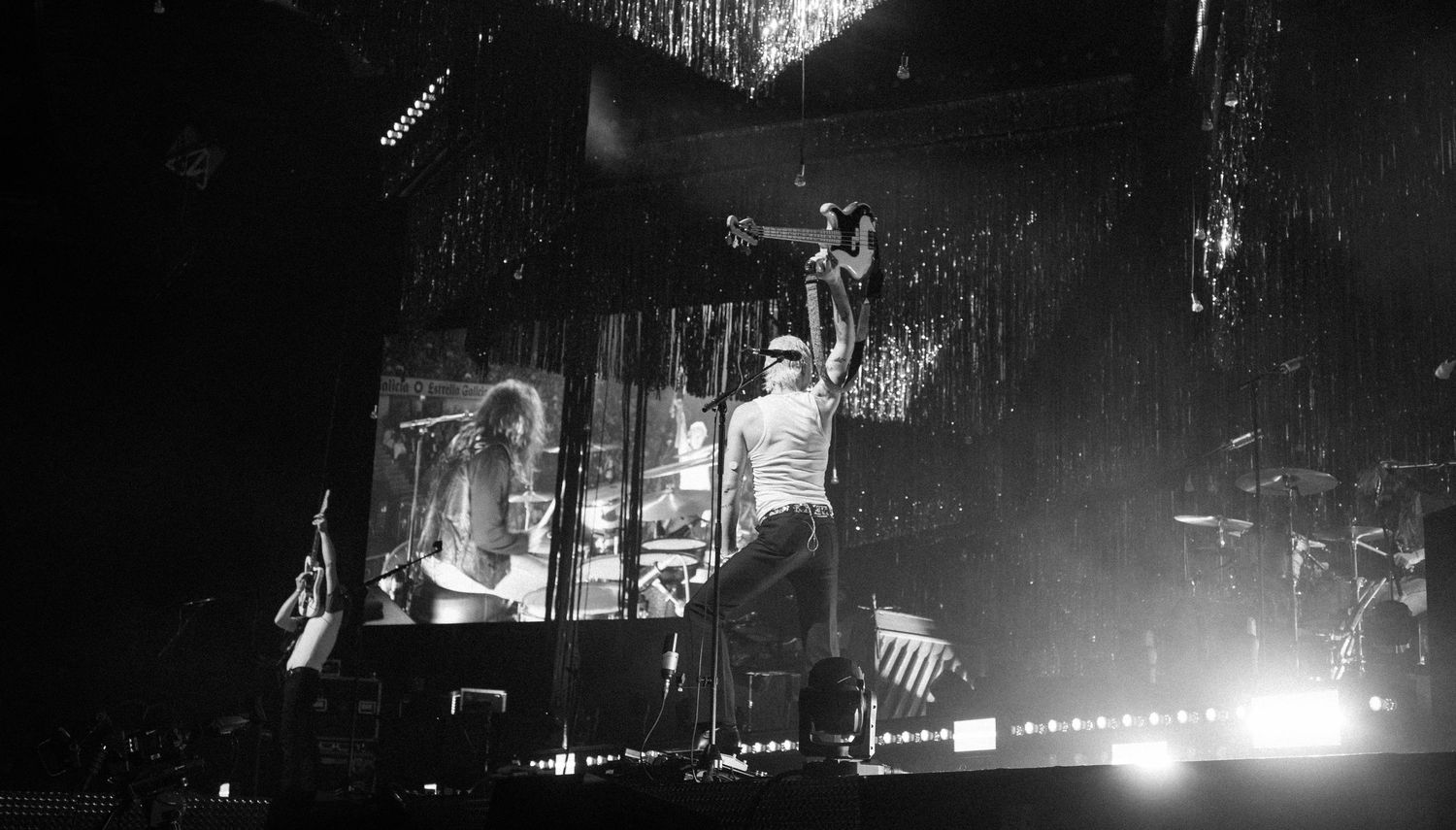 Black and white concert photo showing Wolf Alice energetic stage performance with video screens, directed by Ant Barrett (RESOLVE FILM)