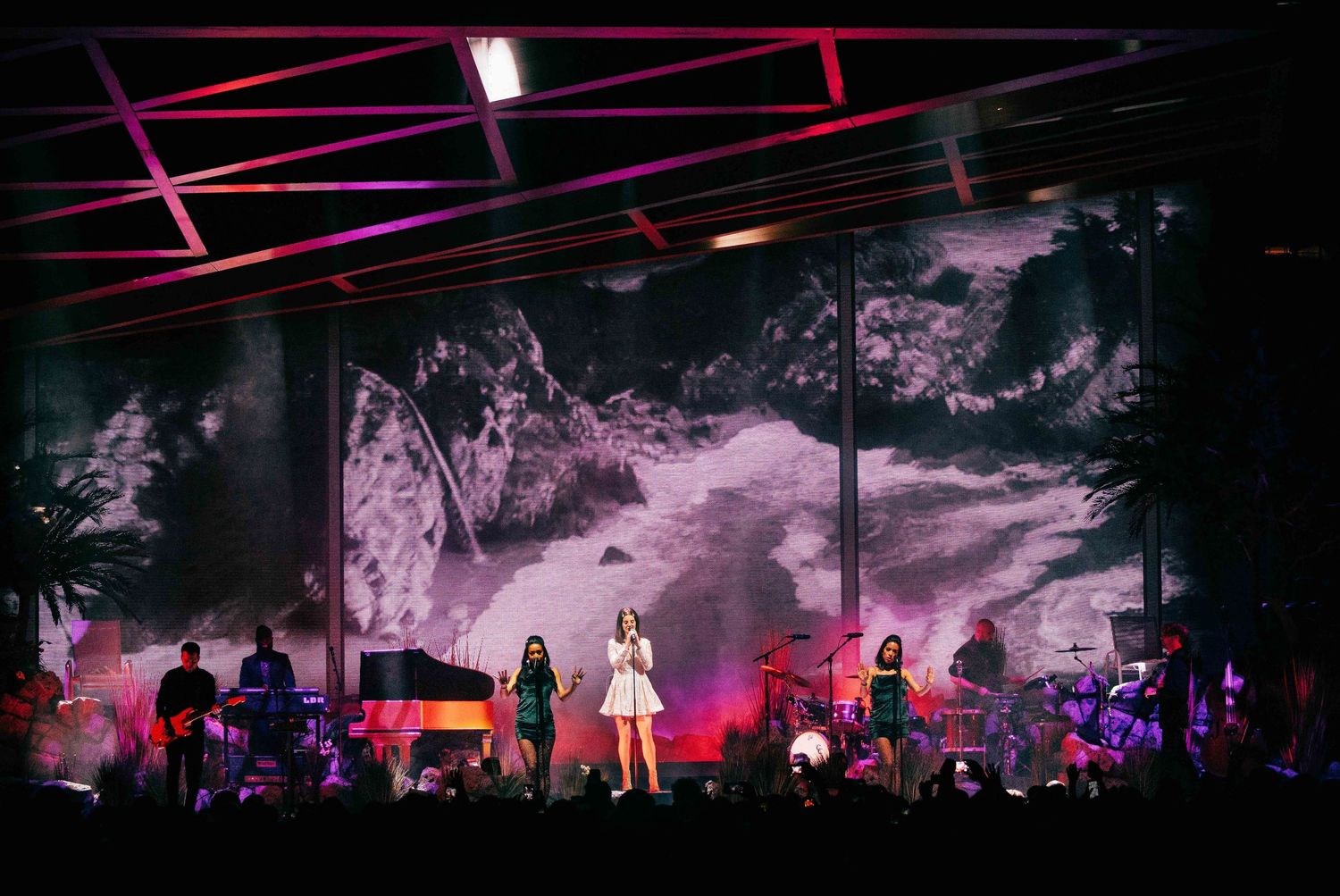 Concert stage with Lana Del Rey and dramatic visual backdrop displaying abstract scenery, directed by Ant Barrett (RESOLVE FILM)