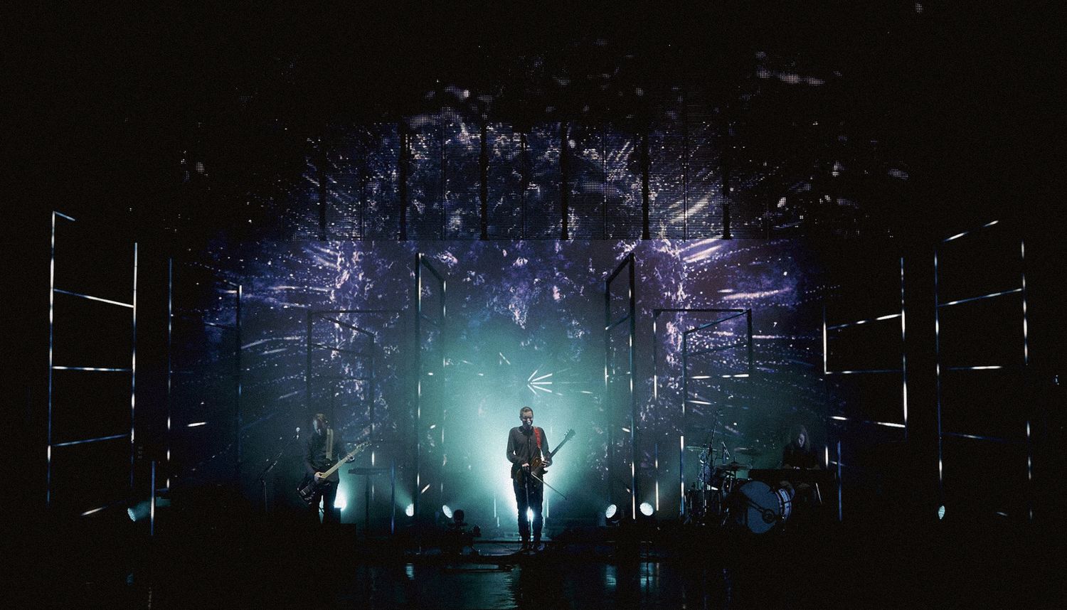 Concert performer Jonsi of Sigur Ros silhouetted against geometric light displays in blue and white, directed by Ant Barrett (RESOLVE FILM)