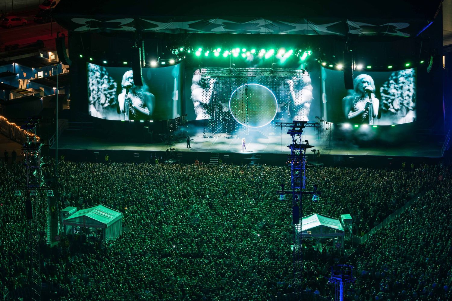 Concert stage illuminated with bright green lights and Lorde creating an atmospheric performance, directed by Ant Barrett (RESOLVE FILM)