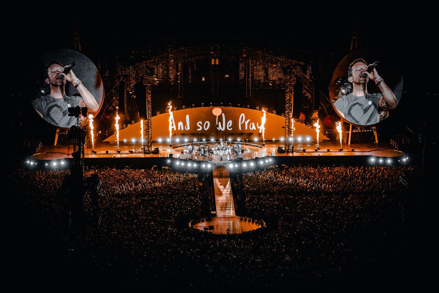 Wide shot of an illuminated Coldplay concert with dramatic lighting and massive crowd, directed by Ant Barrett (RESOLVE FILM)