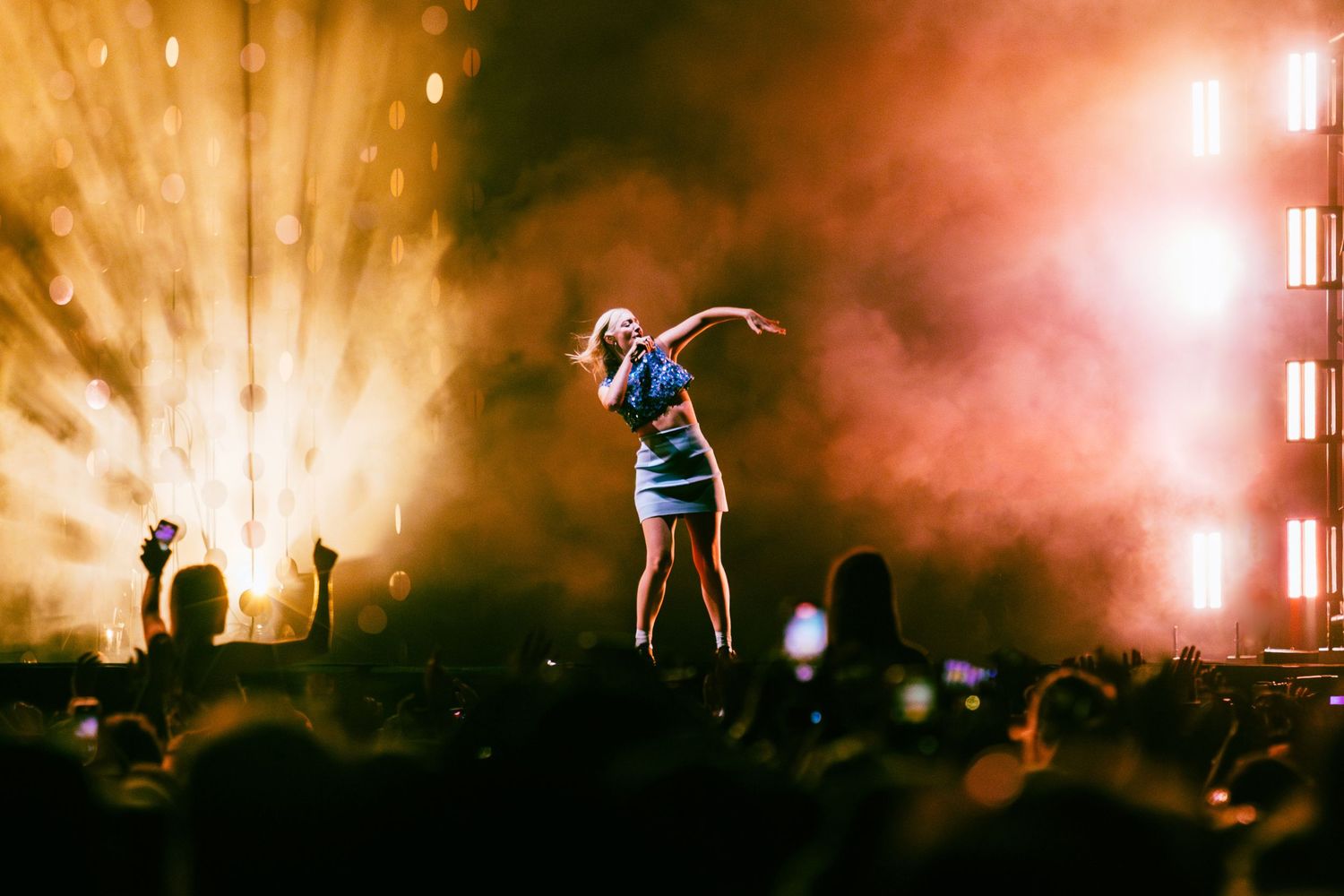 Music festival stage with Lorde bathed in warm orange lighting, directed by Ant Barrett (RESOLVE FILM)
