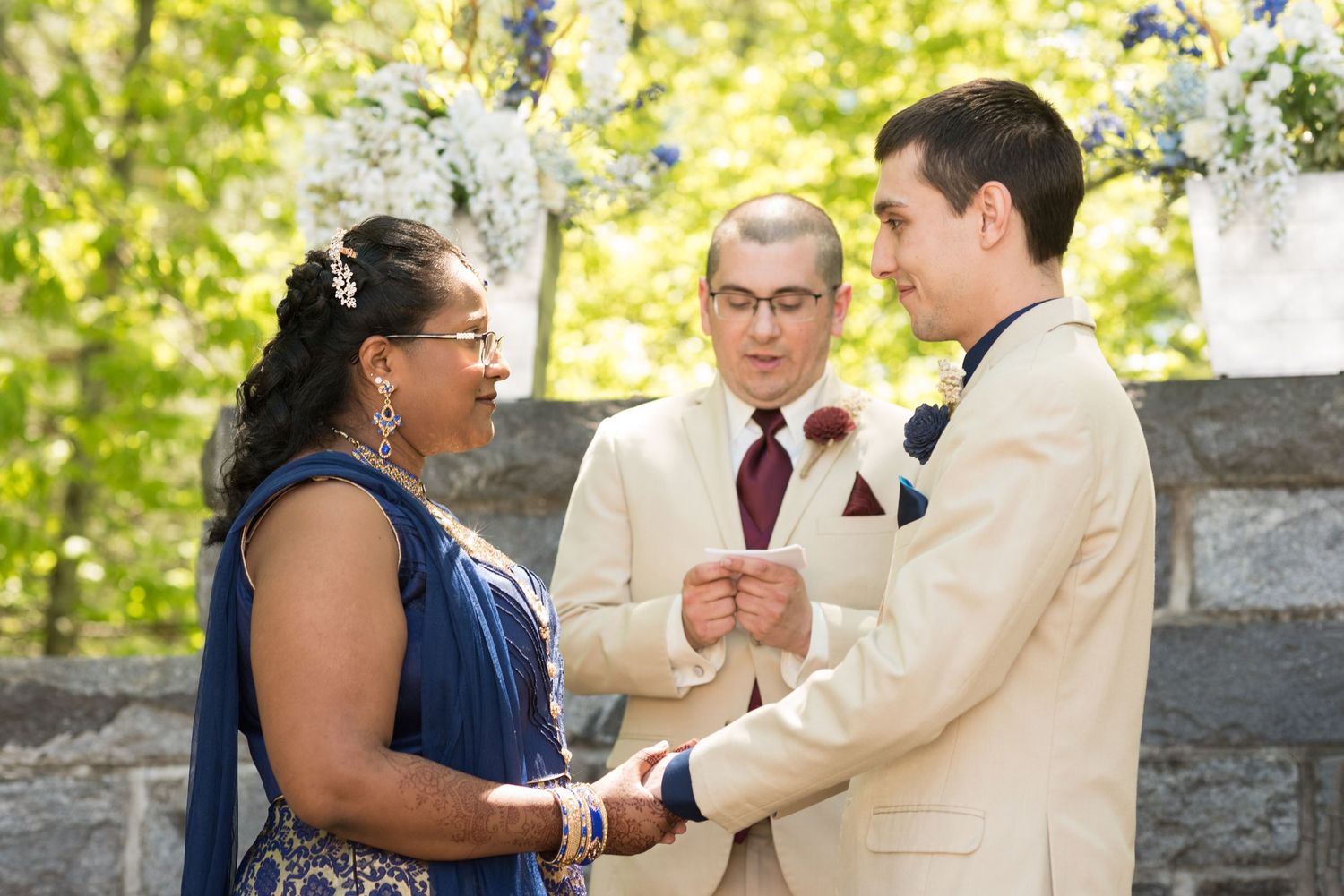 Bride and groom exchange their vows outside in the greenery of Searles Castle in Windham, NH with Leah Ramuglia Wedding Photography