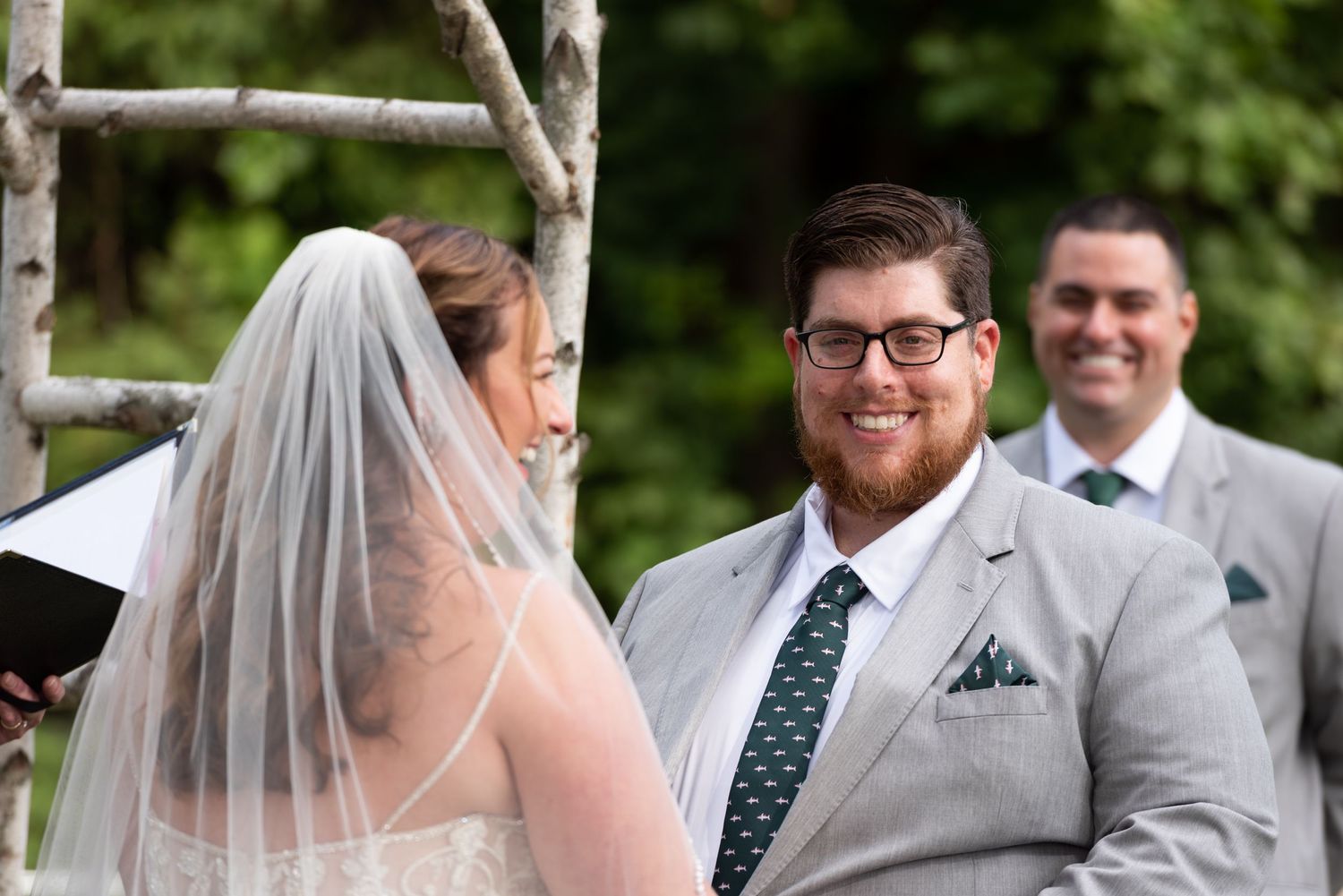 Groom smiles at his bride during their micro wedding at Woodmans of Essex on Boston’s North Shore, photographed by Leah Ramuglia Photography
