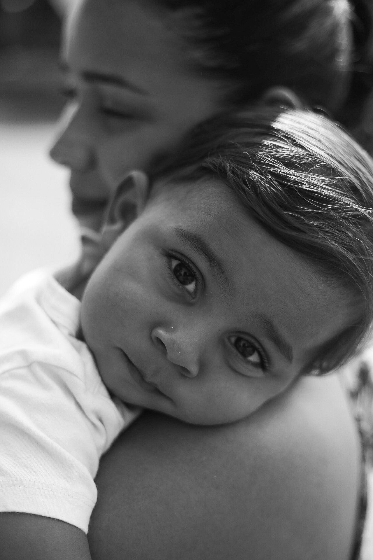 Close-up black and white portrait showing emotional connection in tender side profile composition.