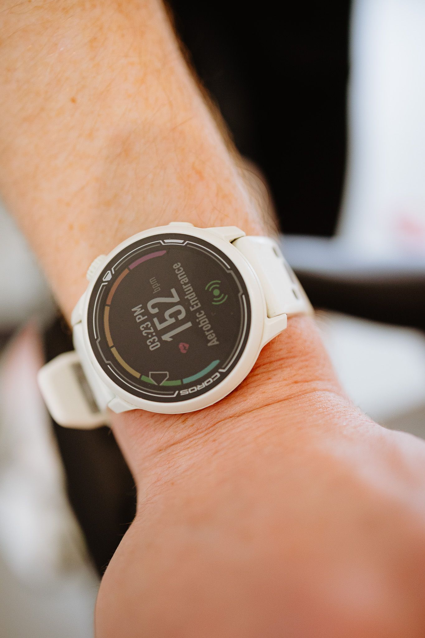 Close-up sequence showing a white smartwatch displaying fitness tracking data on a dark digital screen.