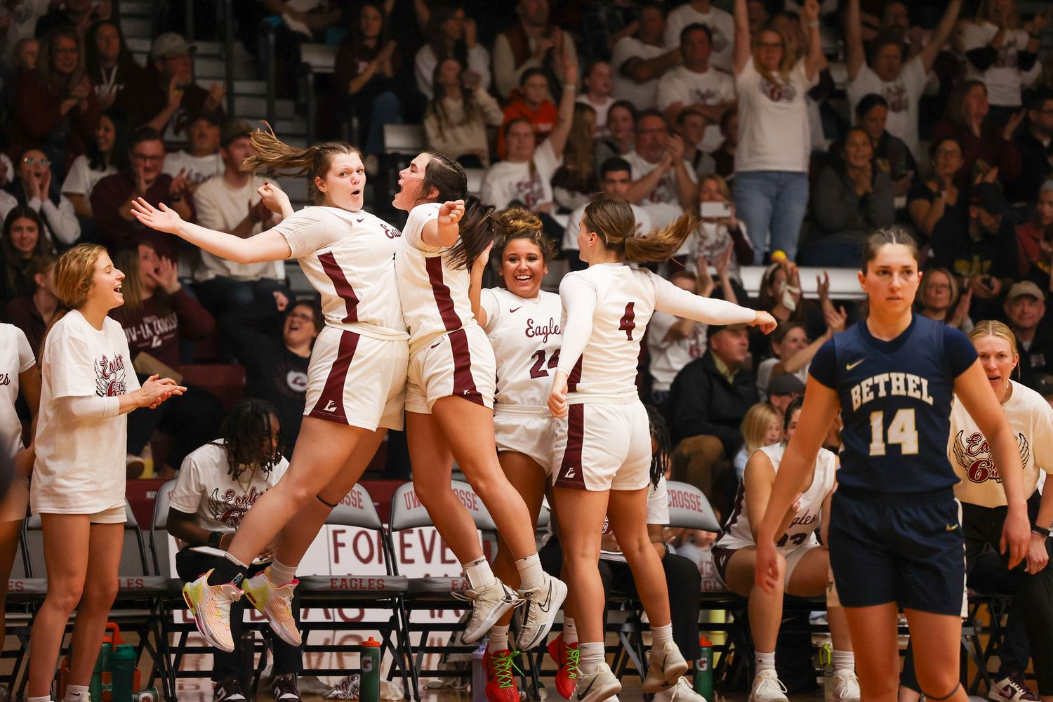 A volleyball team celebrates together on the court during an intense match.